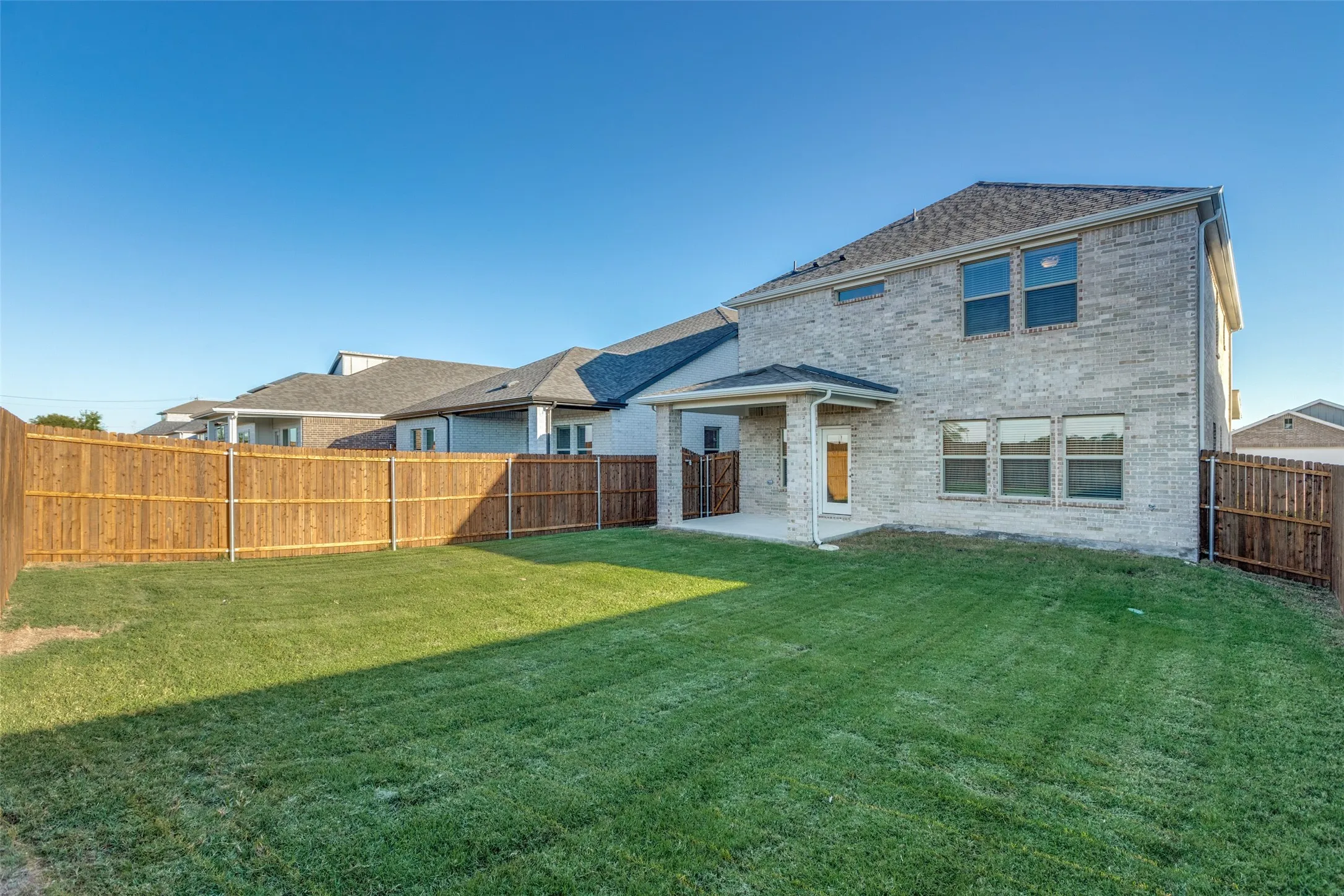 Rear view of house with a patio and a yard