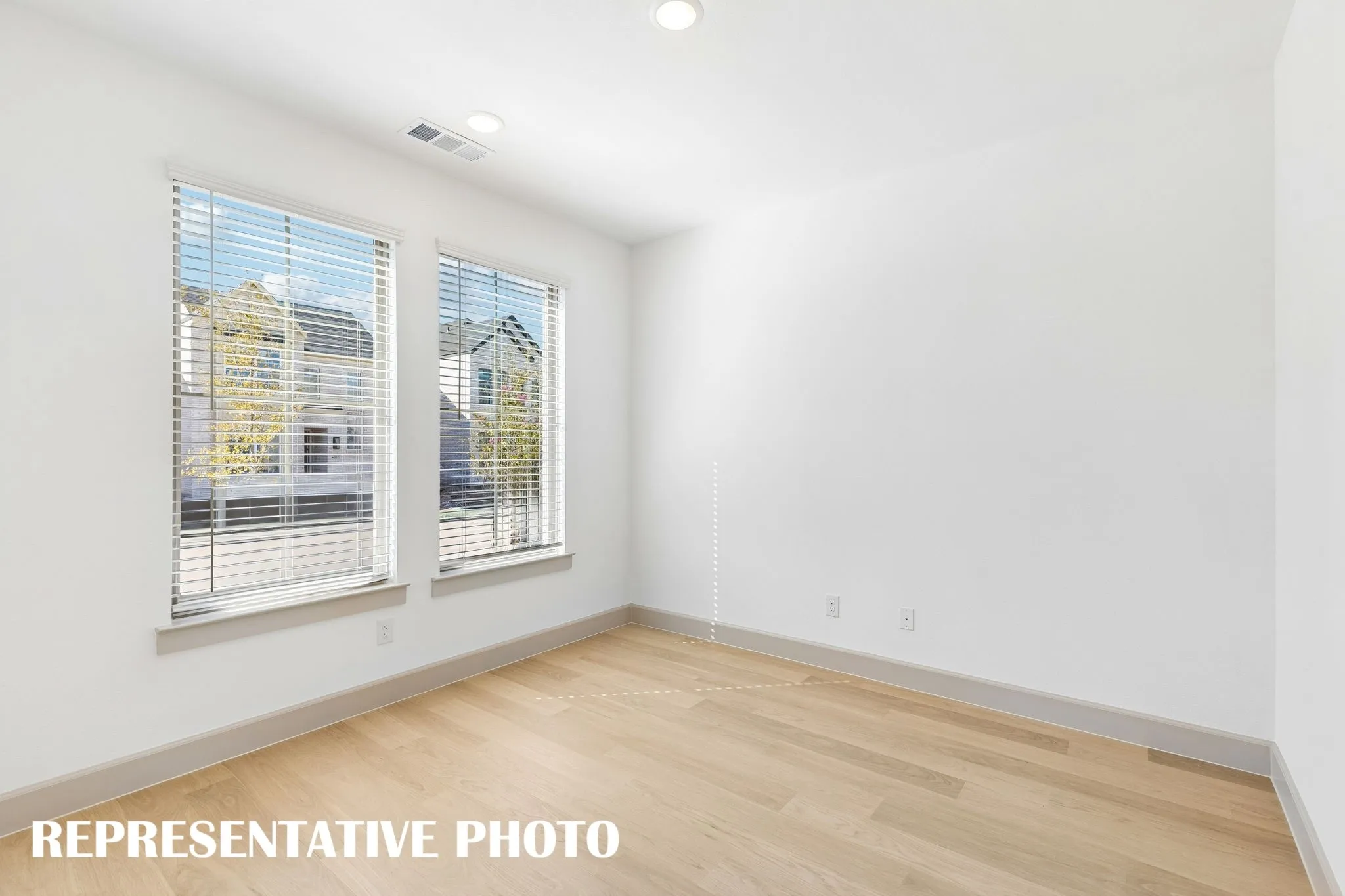 The professional needing to work from home will appreciate this light filled, private home office.  REPRESENTATIVE PHOTO