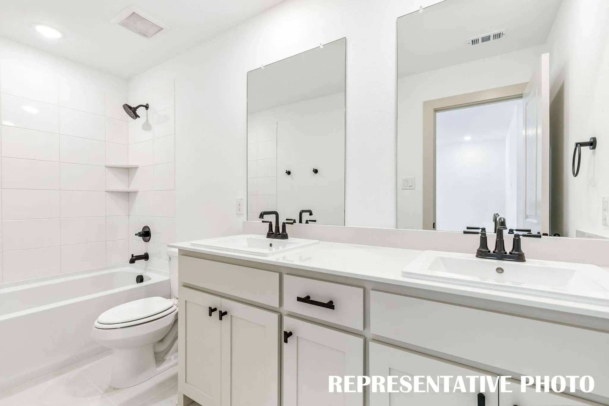 Guests will enjoy their own vanity space in this thoughtfully designed guest bath.  REPRESENTATIVE PHOTO