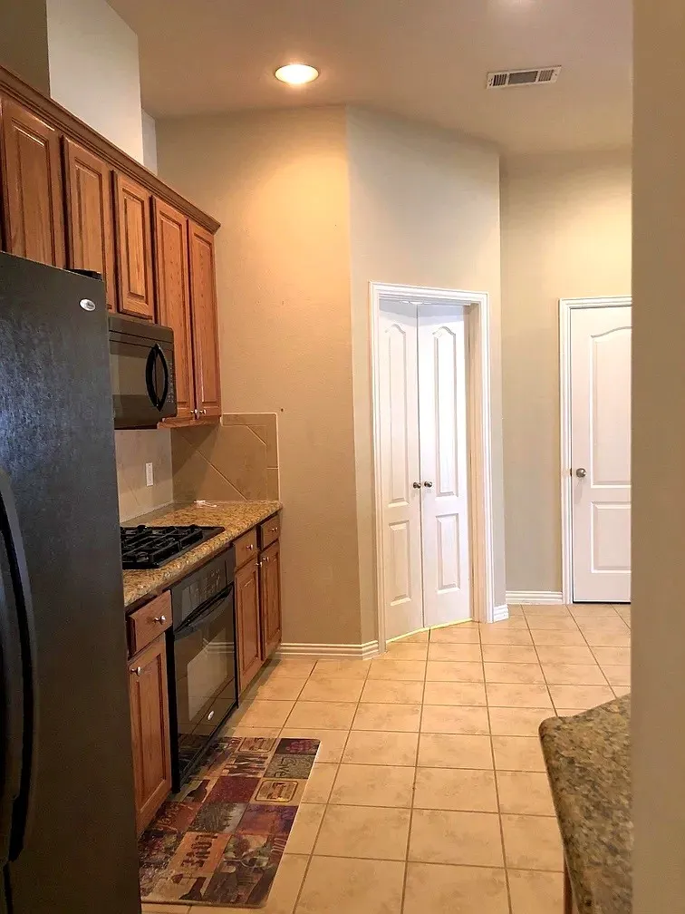 Kitchen featuring wood cabinetry, integrated microwave, built-in oven, and a gas cooktop
