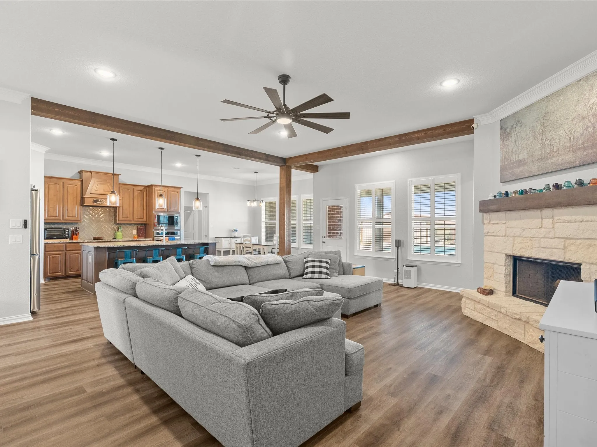 open concept living room with exposed cedar beams