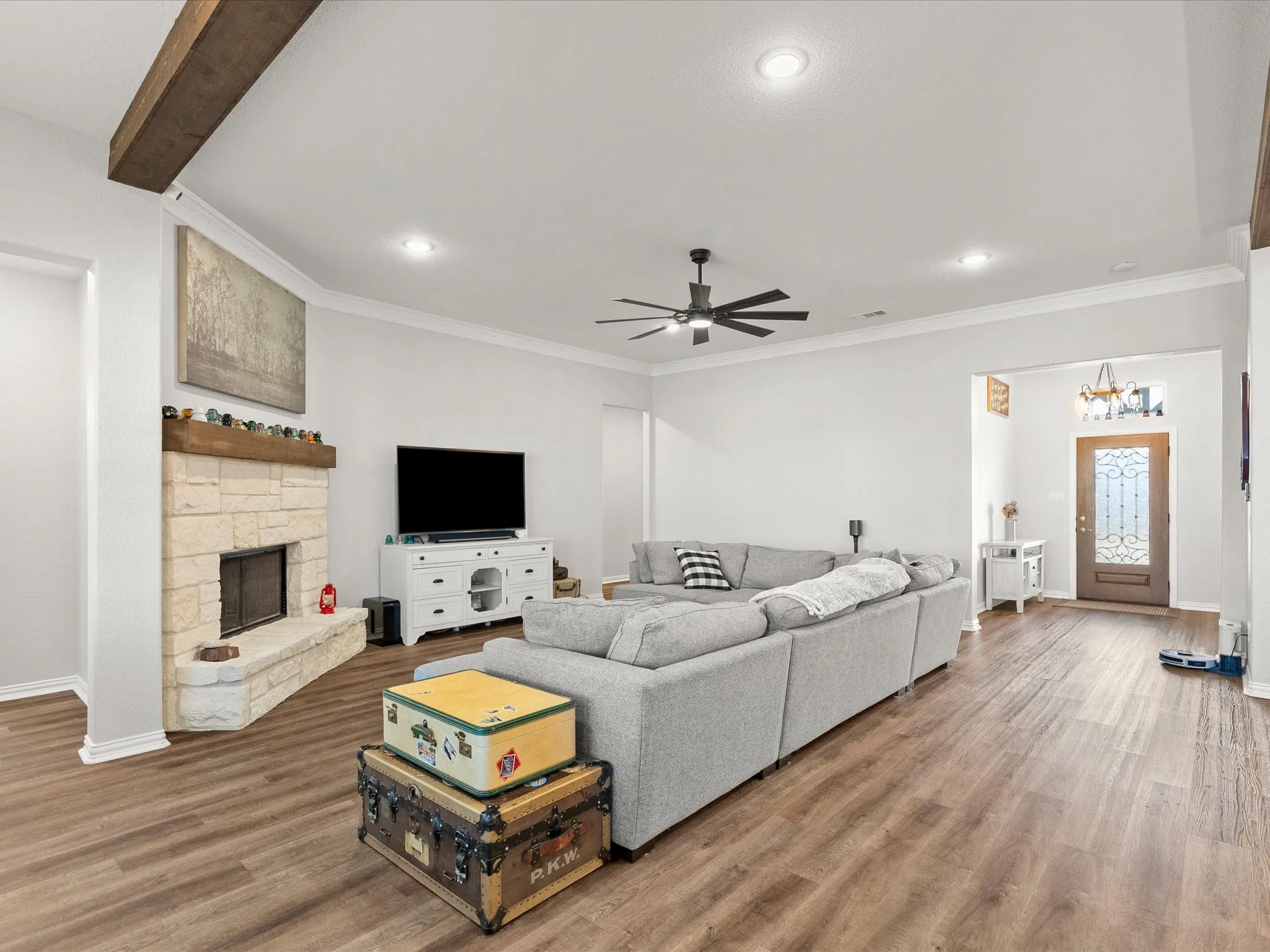 wood-burning fireplace with cedar beam mantle