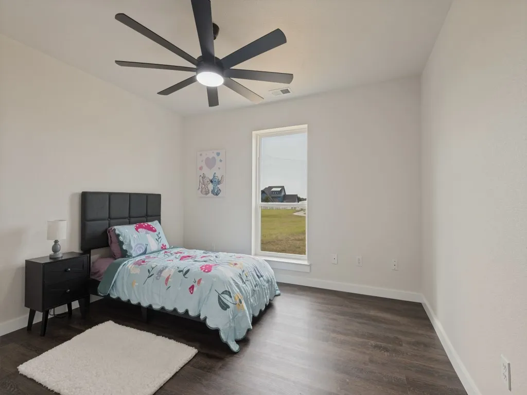Recessed lighting with a ceiling fan, wood-finish flooring, and a large window