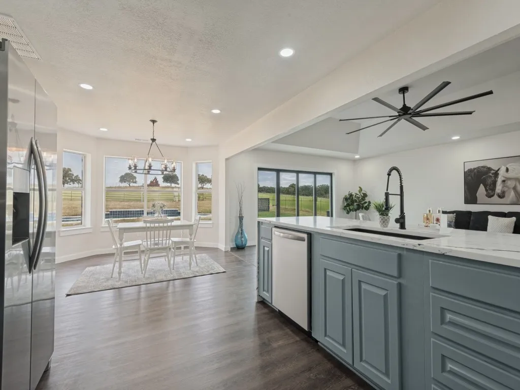 Open-concept living space with dark wood-finish flooring, recessed lighting, and a contemporary ceiling fan