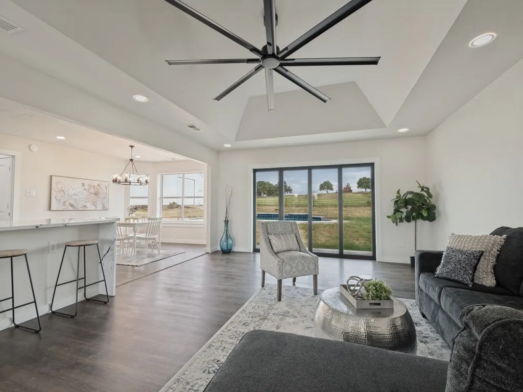 Tray ceiling with a large ceiling fan and recessed lighting