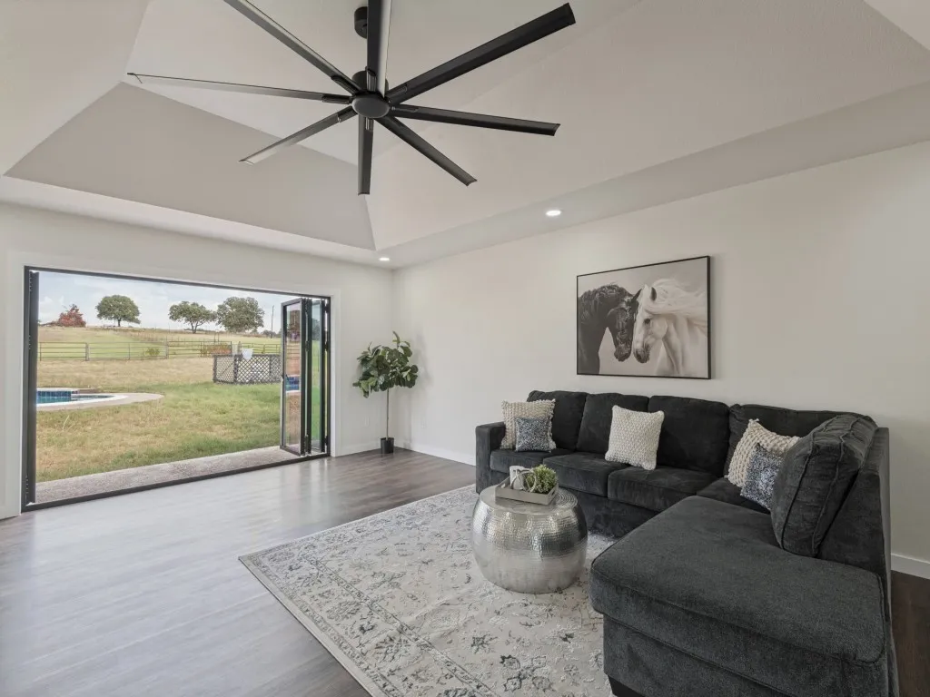Tray ceiling with recessed lighting and a large ceiling fan