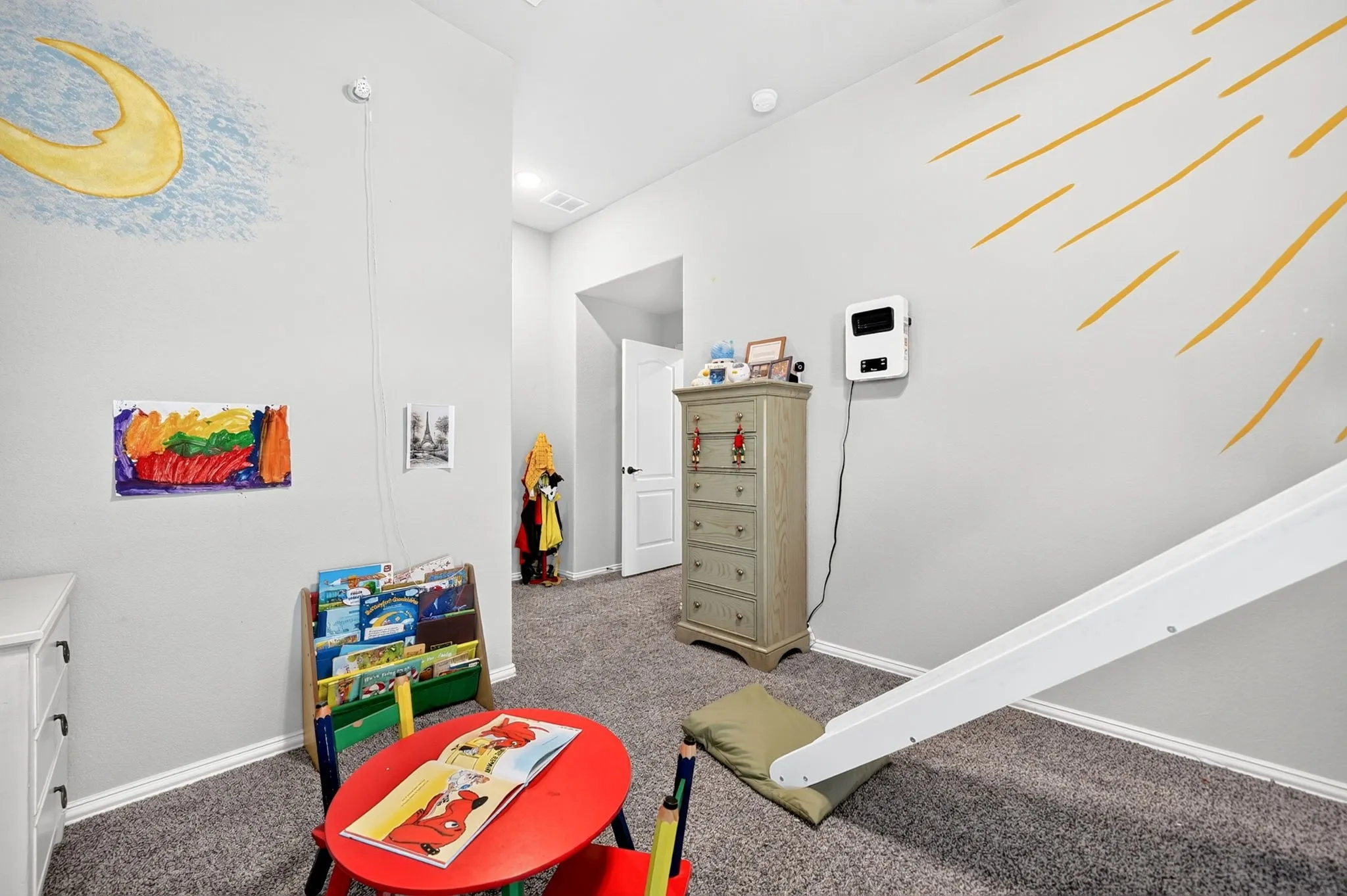 Carpeted flooring extending into the hallway, white trim, and a white interior door