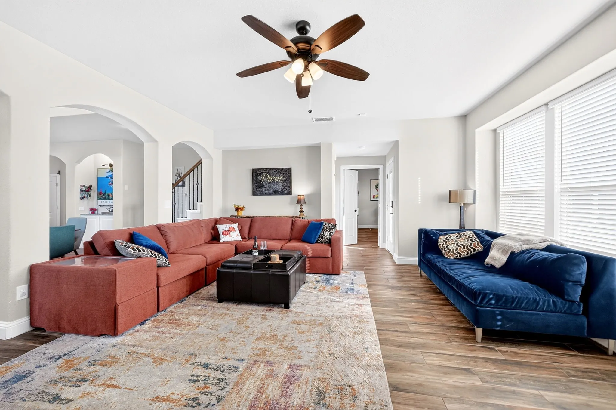 Wood-finish flooring throughout, complemented by a ceiling fan with integrated lighting