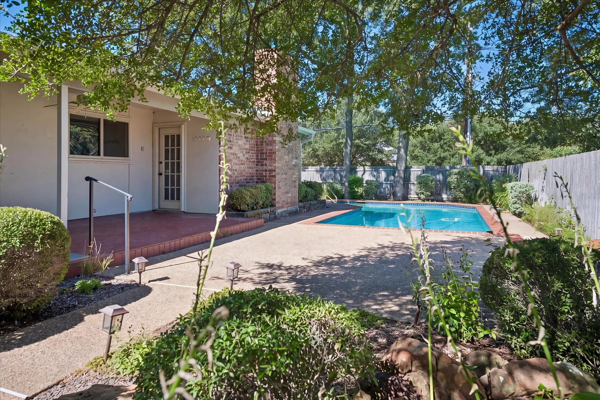Mature landscaping, covered patio and sparkling pool!