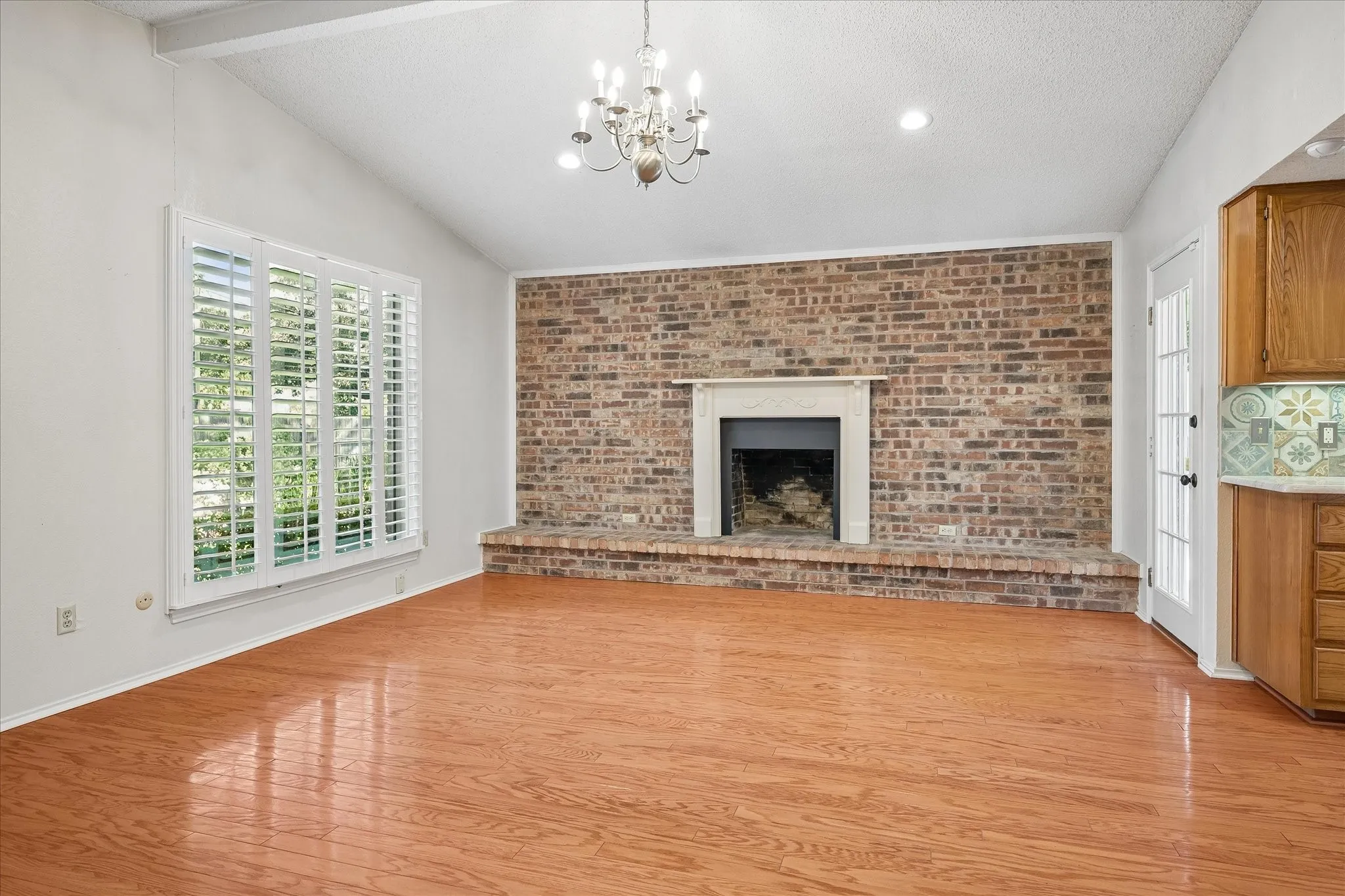 Another view of the family room with brick fireplace.