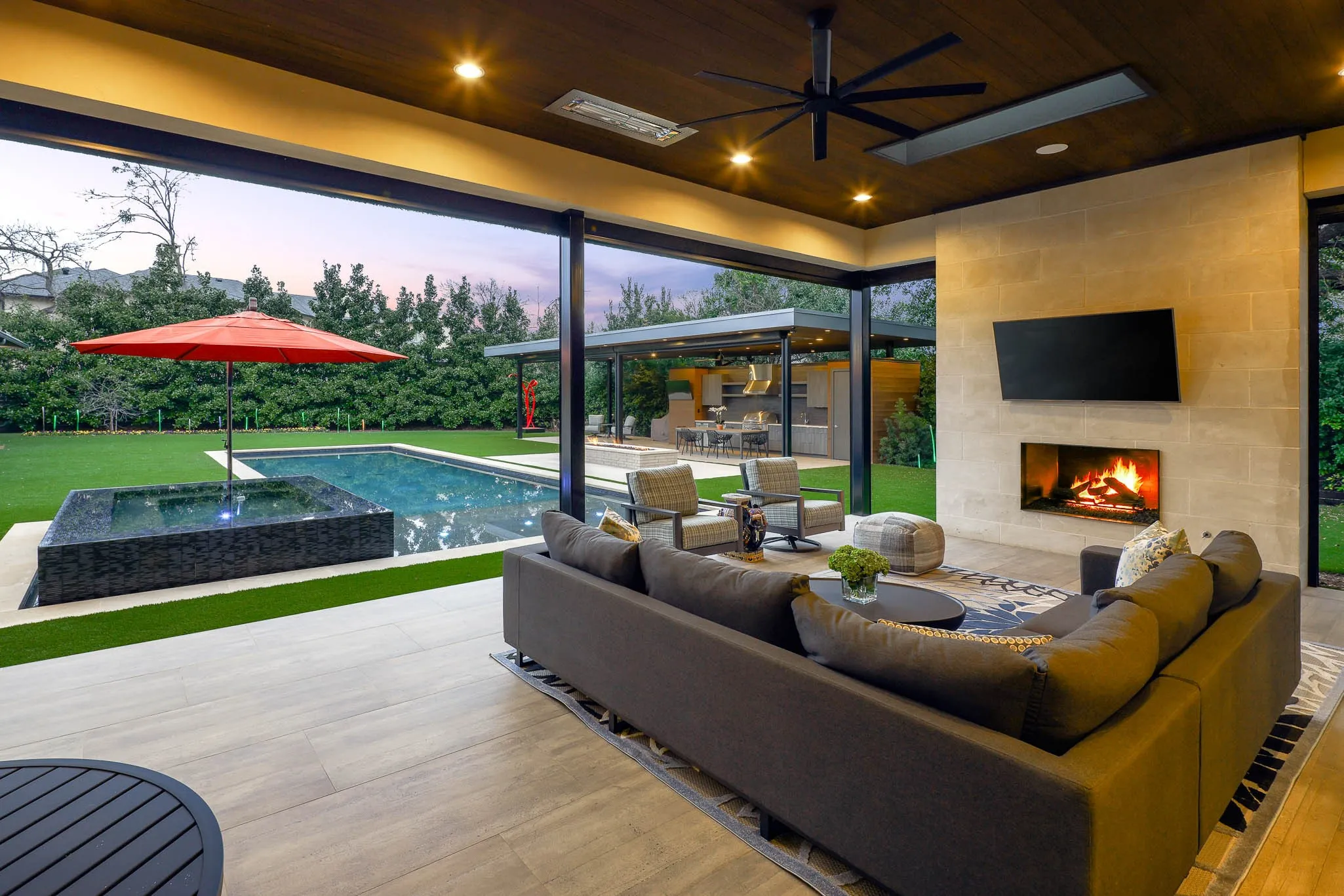 Outdoor covered loggia with sitting area, gas fireplace, built-in heaters and Phantom screens