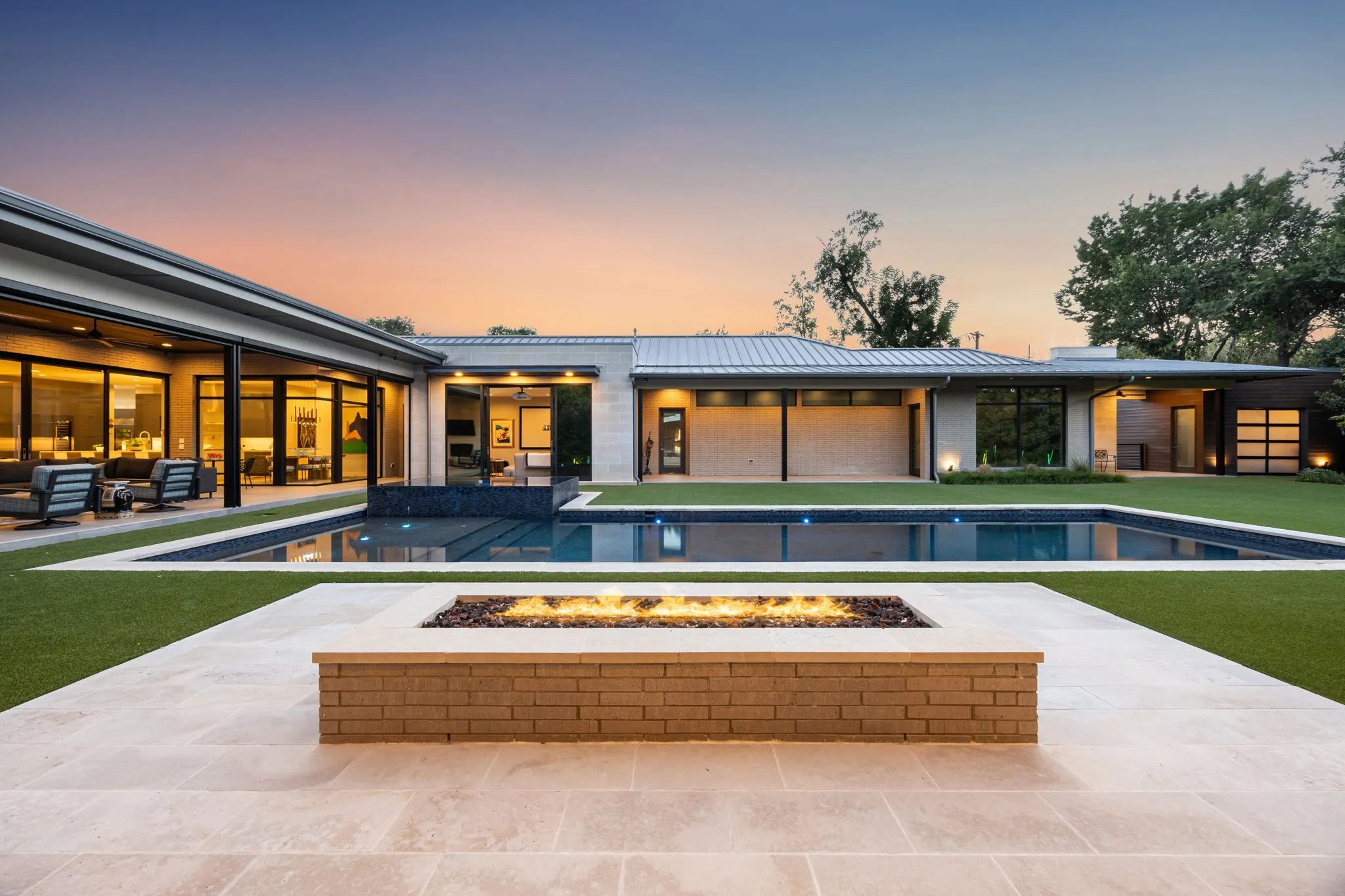 Covered cabana with fire pit adjacent to pool and spa