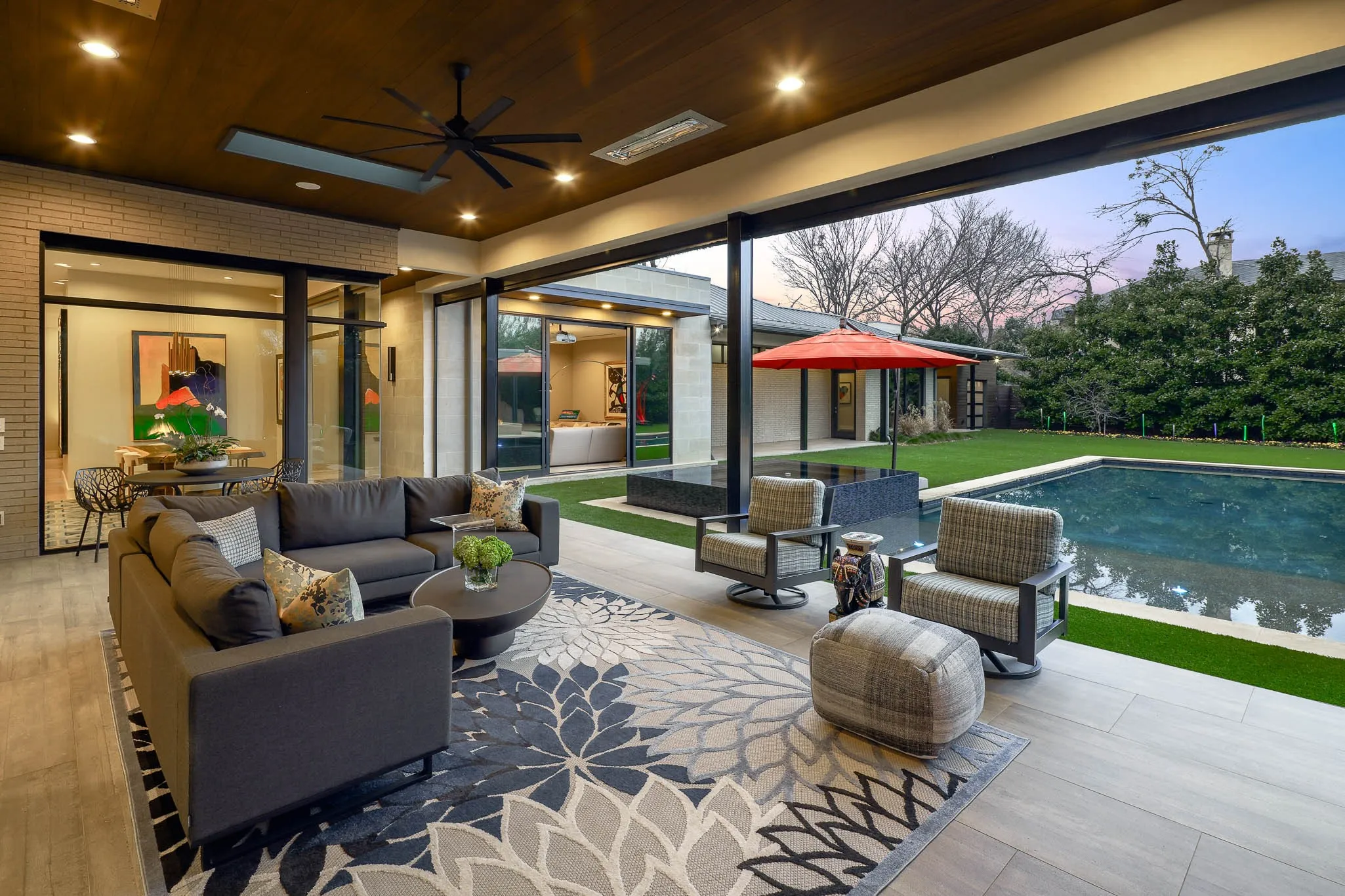 Outdoor covered loggia with sitting area, gas fireplace, built-in heaters and Phantom screens
