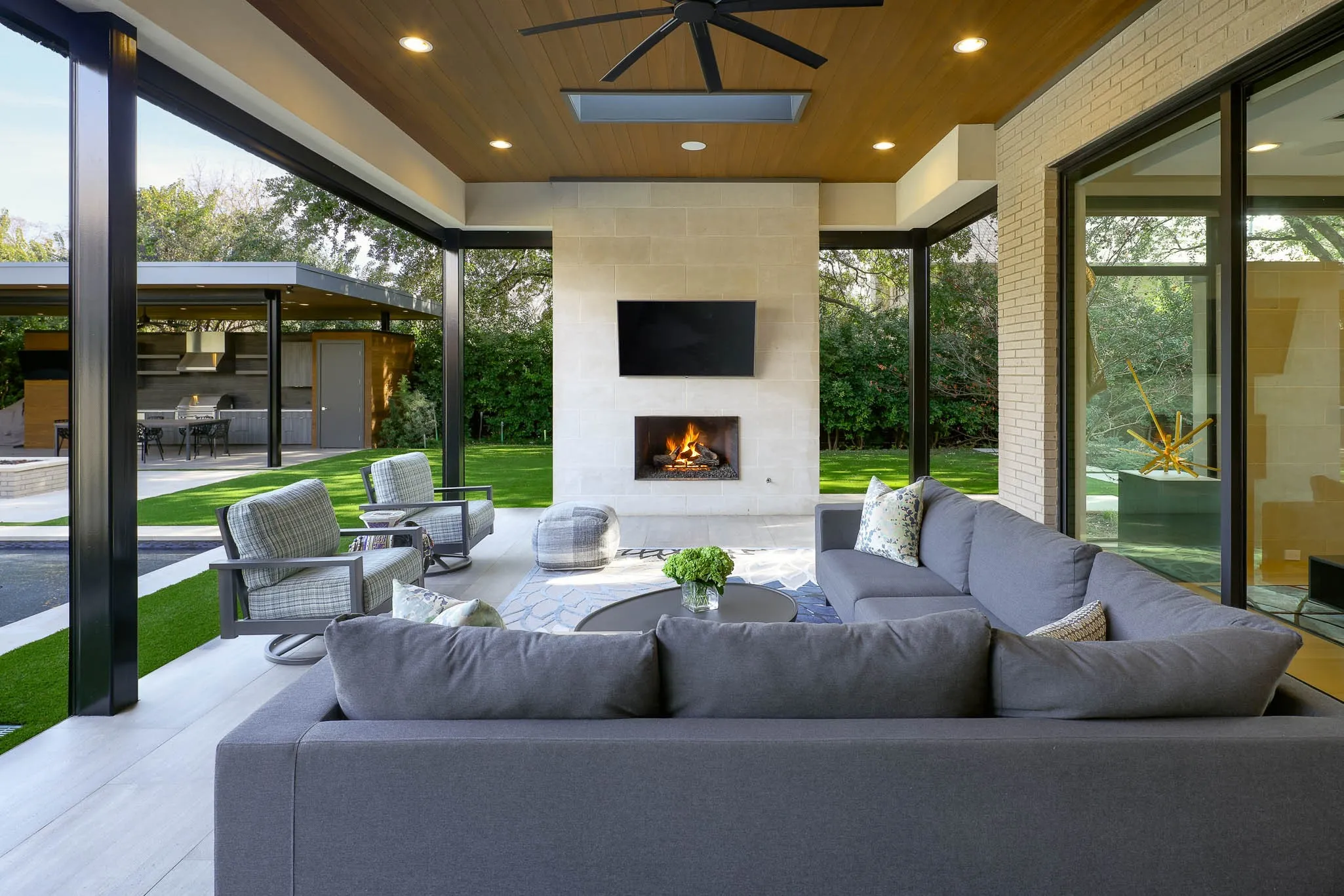 Outdoor covered loggia with sitting area, gas fireplace, built-in heaters and Phantom screens