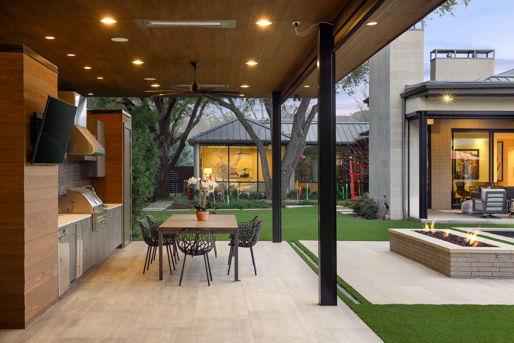Covered cabana with built-in heaters, grill, ice maker, beverage refrigerator and remote solar screens