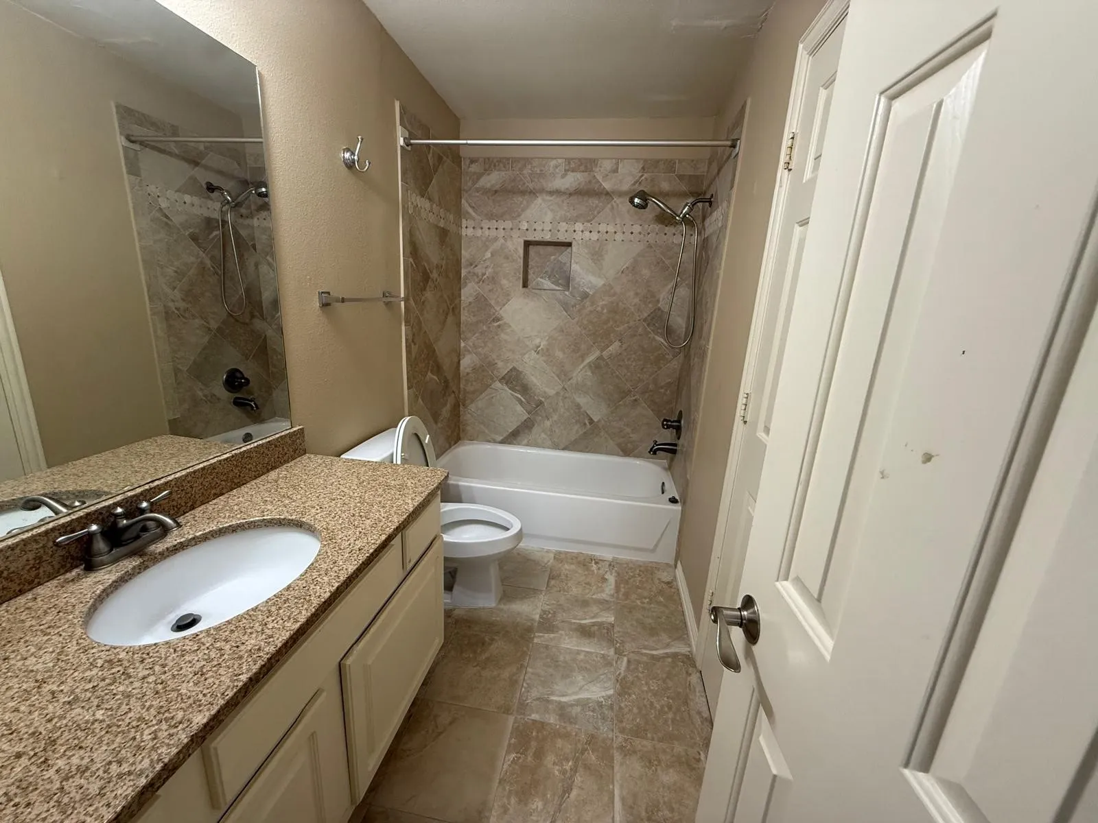 Bathroom featuring a vanity with an oval sink, textured countertop, and lower cabinetry