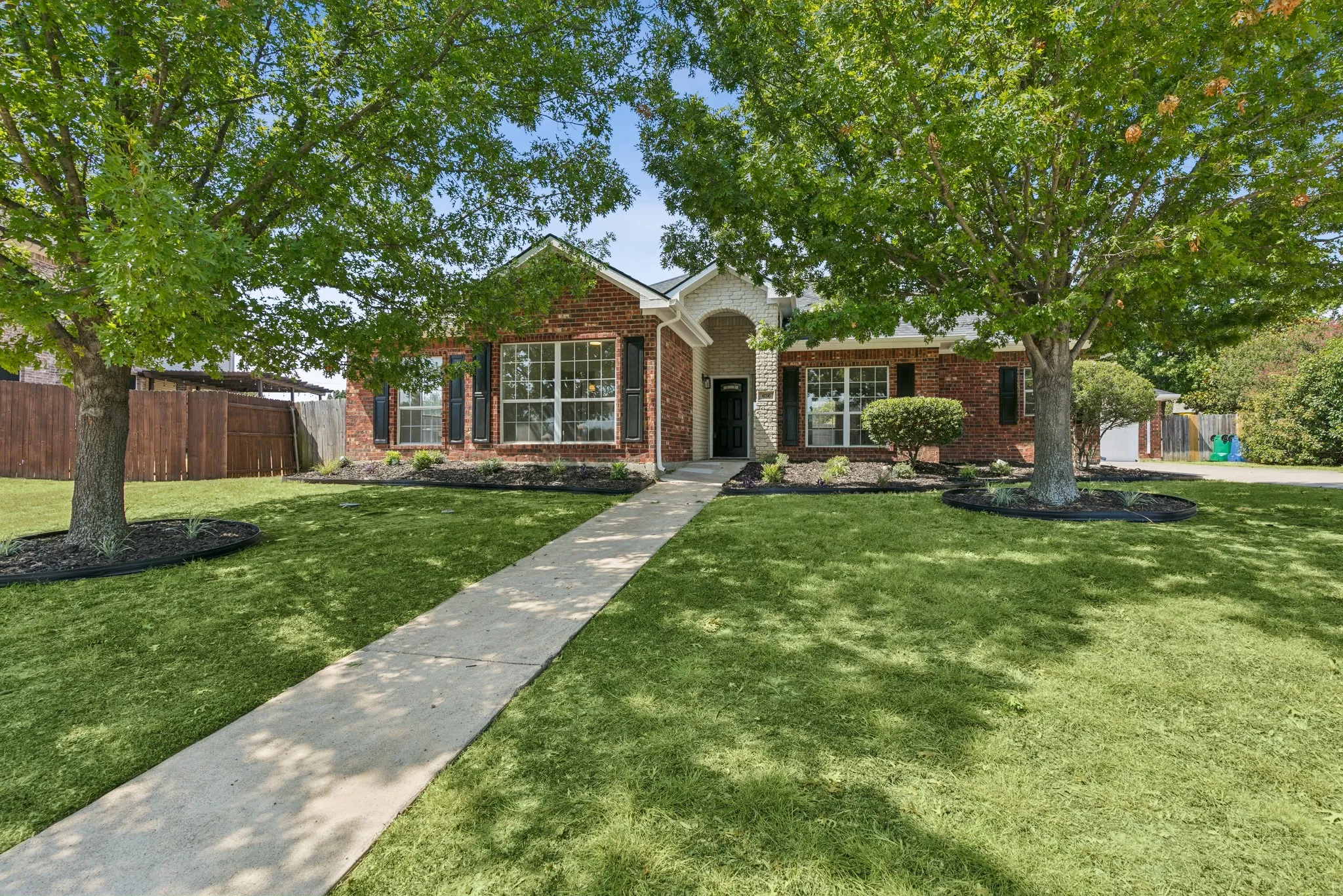 Brick exterior with stone accents and a covered entry