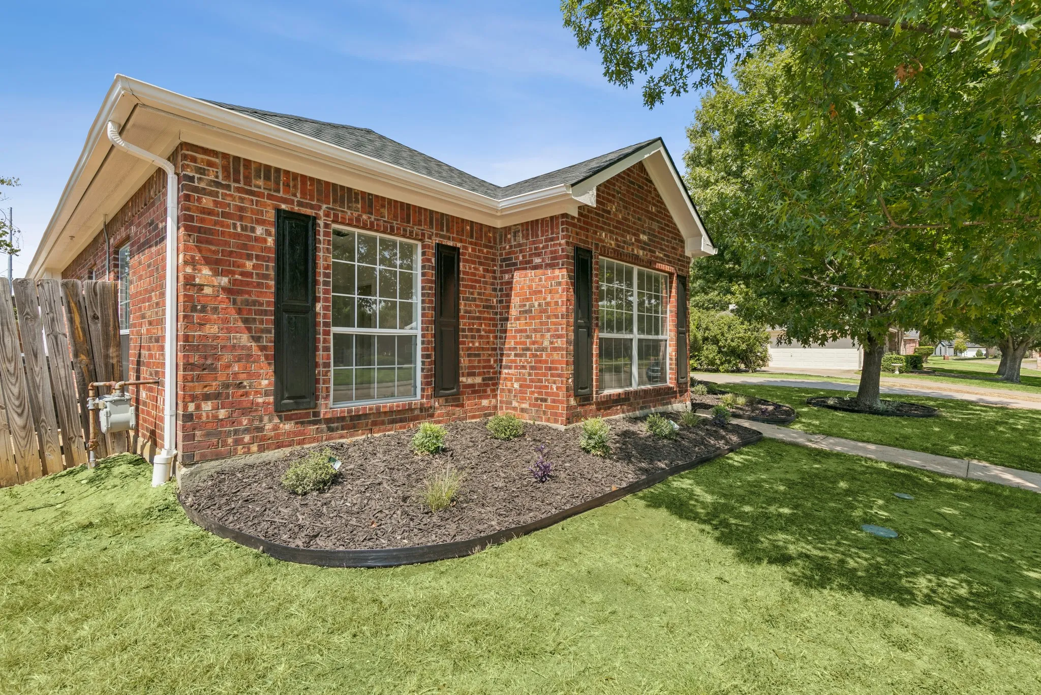 Brick exterior with black shutters and white trim