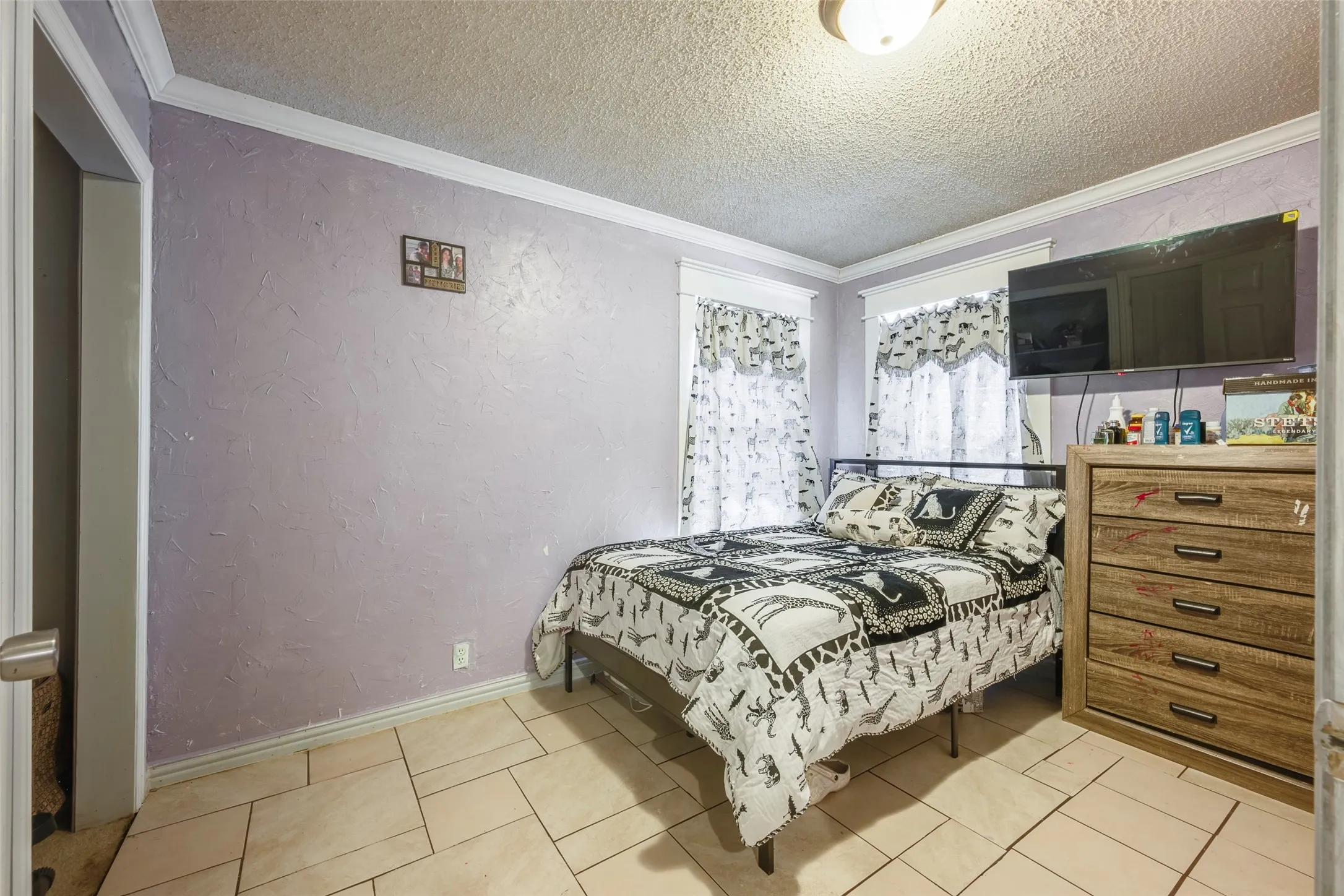Tile flooring with a matte finish, crown molding, and recessed windows