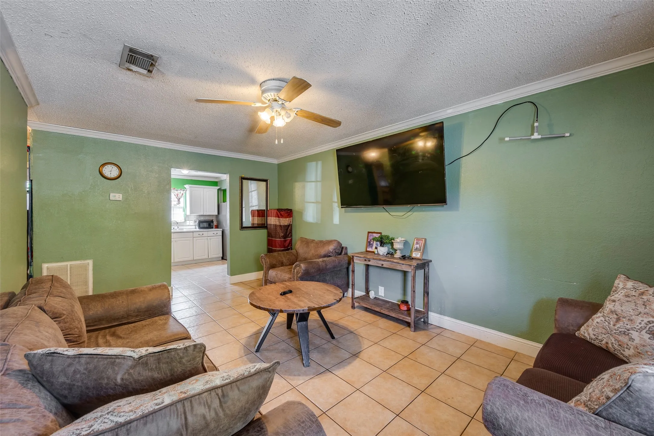 Recessed lighting, ceiling fan, crown molding, and tile flooring