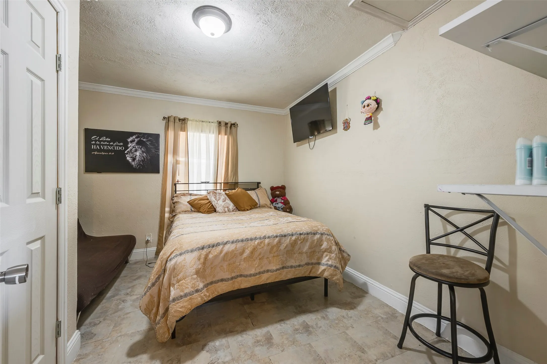 Recessed lighting, crown molding, paneled door, and tile flooring