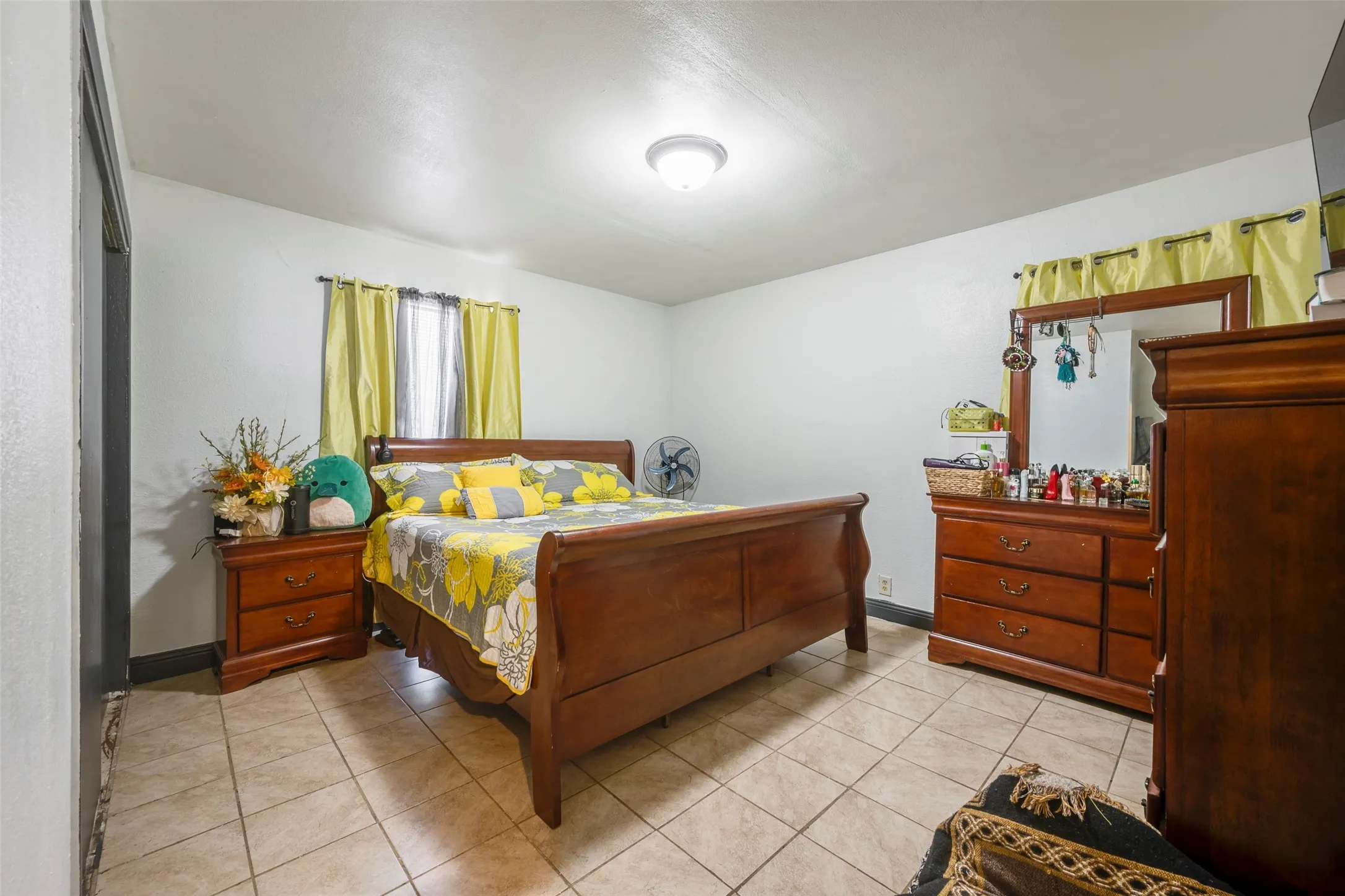 Tile flooring throughout with a ceiling-mounted light fixture