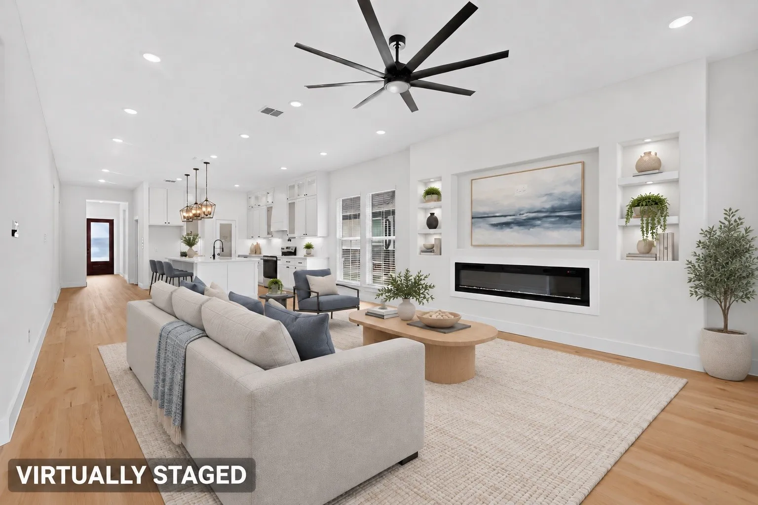 Open-concept living space featuring wood-finish flooring, recessed lighting, and a modern ceiling fan