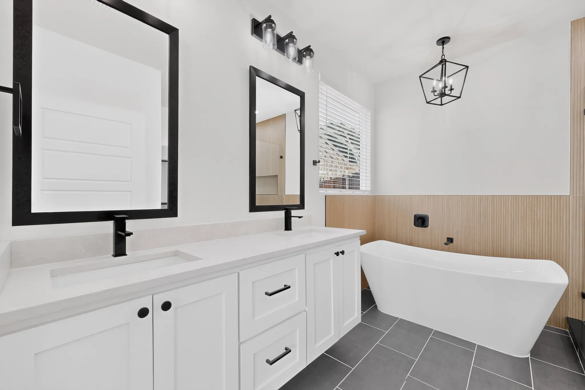 Dual vanity with undermount sinks, white cabinetry, and matte black hardware