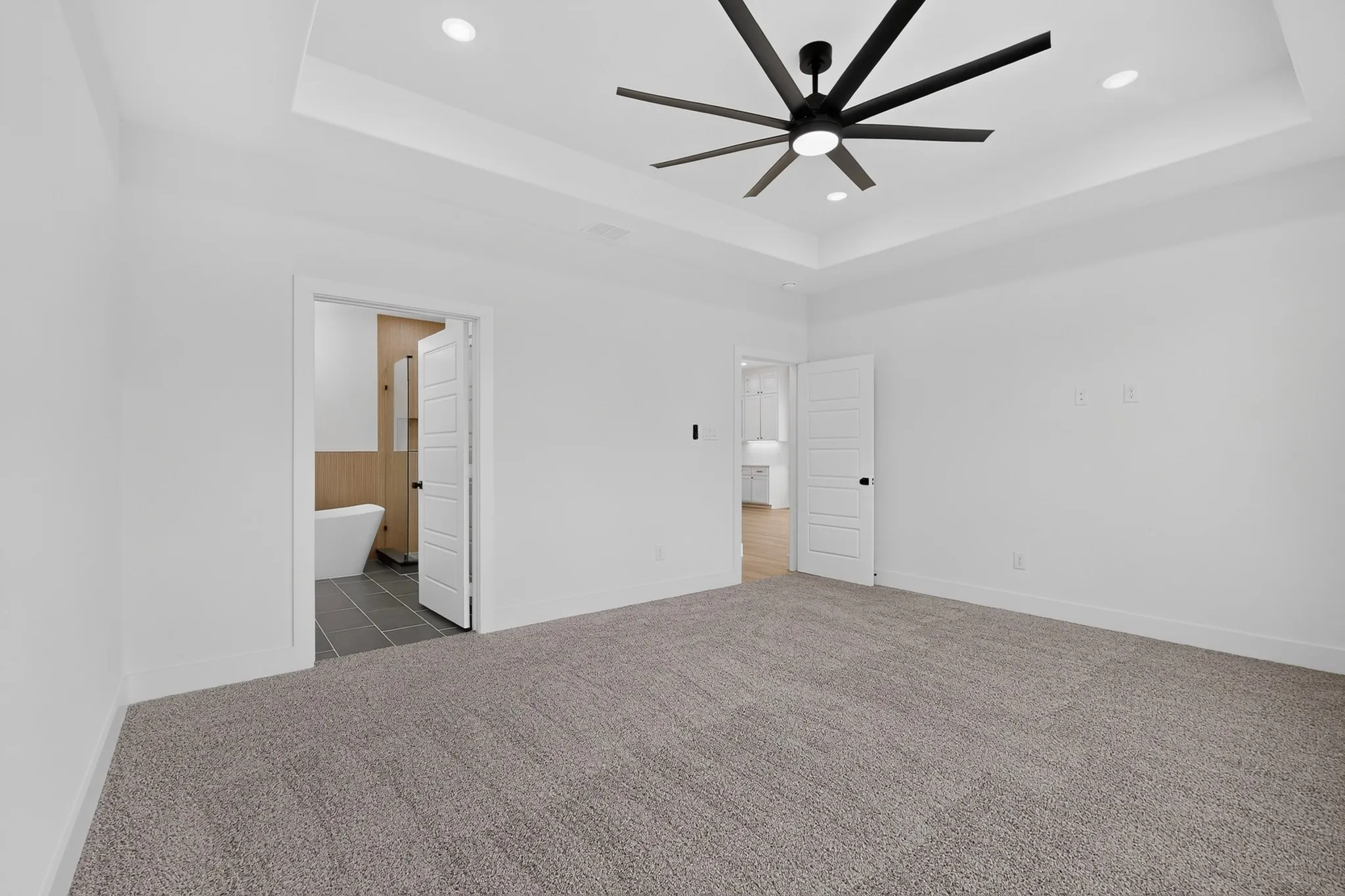 Tray ceiling with recessed lighting and a contemporary ceiling fan