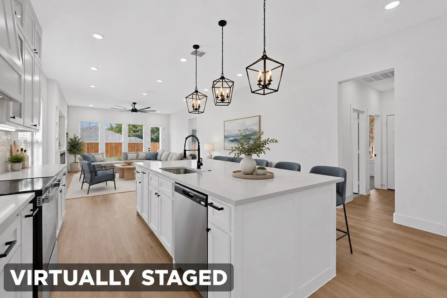 White kitchen cabinetry with black hardware, stainless steel appliances, and wood-finish flooring