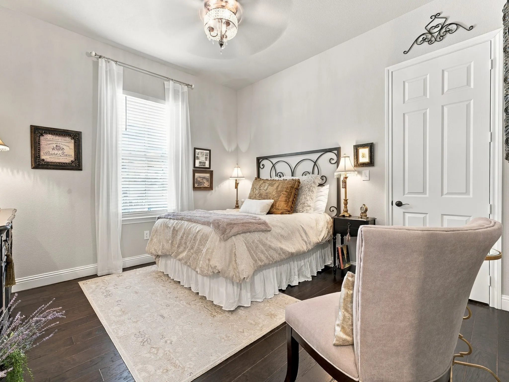 Dark wood-finish flooring, white paneled door, and a decorative ceiling fan
