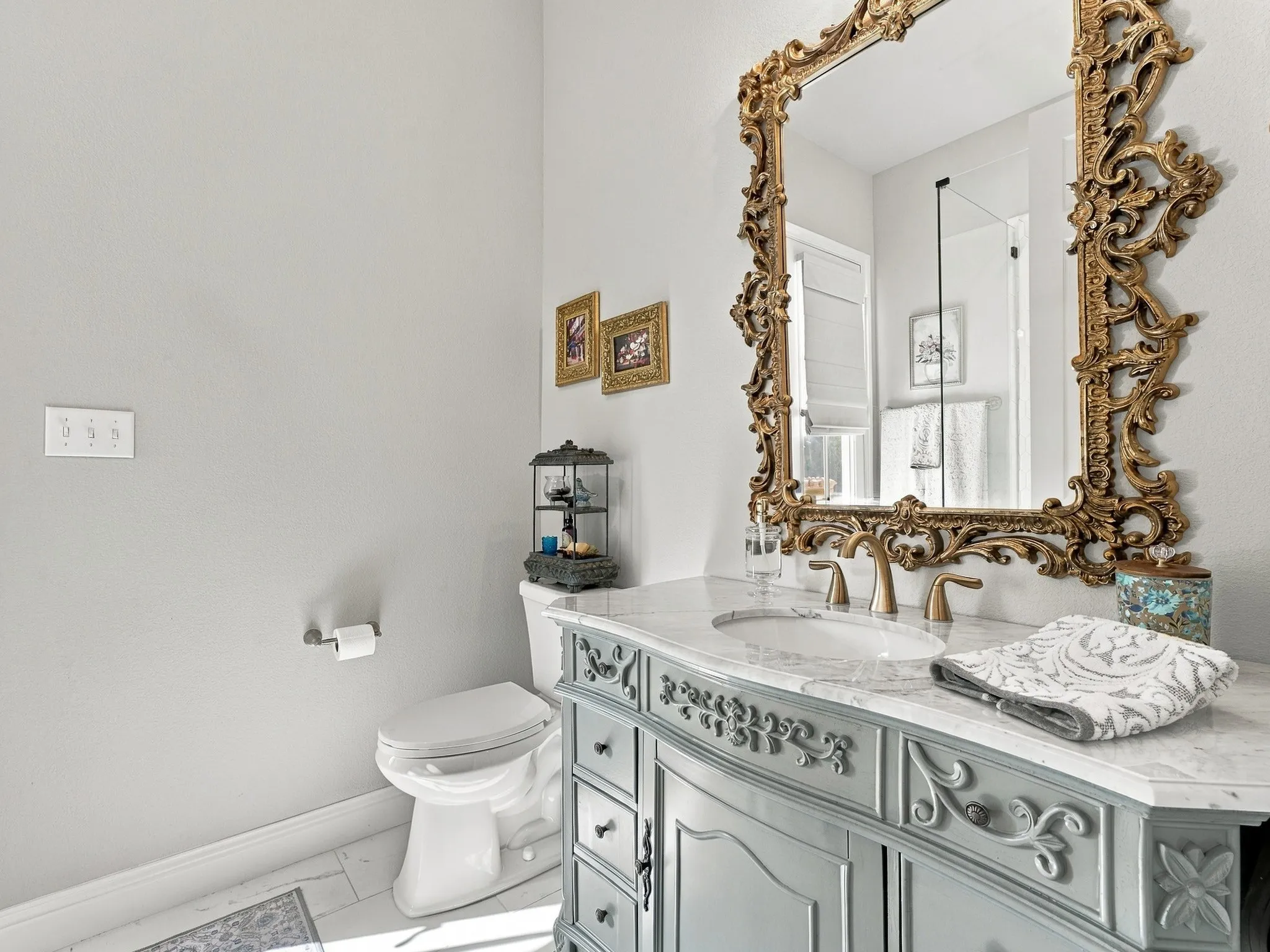 Vanity with ornate trim, marble countertop, and integrated sink right off the back patio.
