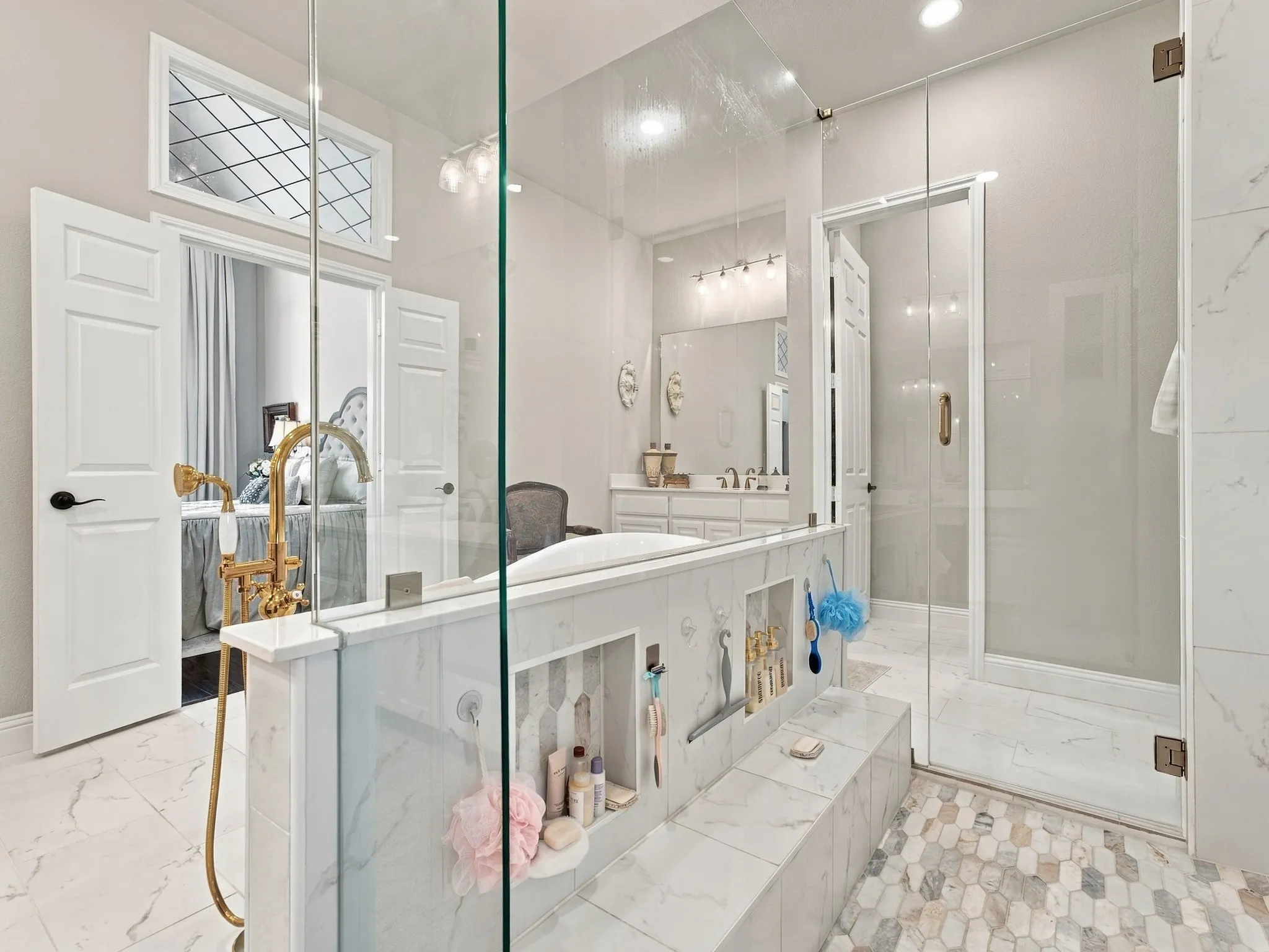 Spacious bathroom featuring a glass-enclosed shower, built-in bathtub, dual vanity, and mosaic tile flooring