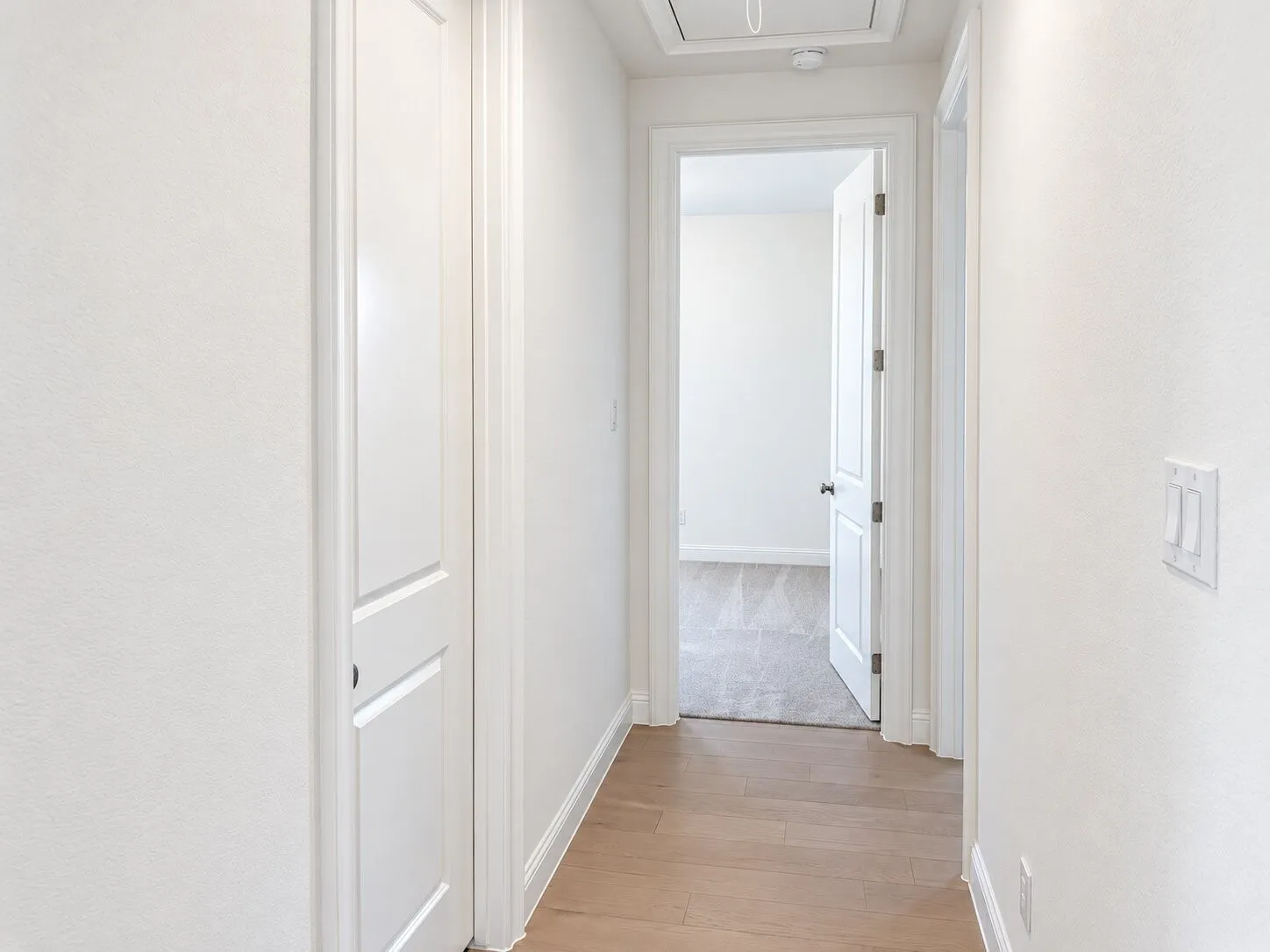 Wood-finish flooring extending through the hallway