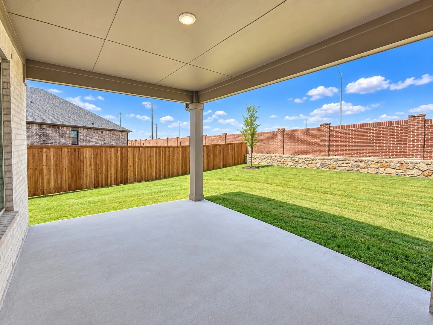 Covered patio with a concrete slab, recessed lighting, and a columned support