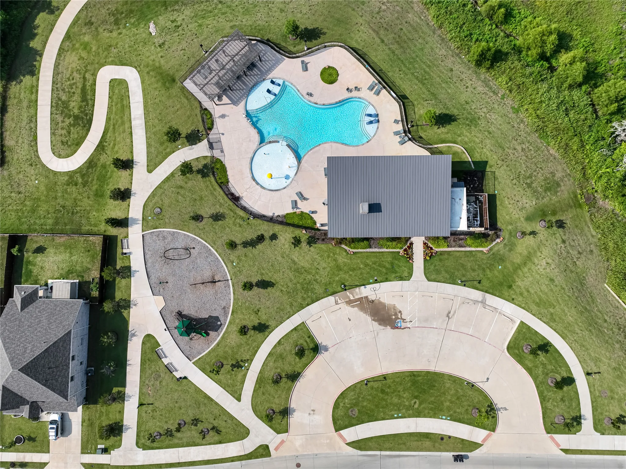 Community swimming pool, playground area, walking paths, expansive green spaces, and a single-story community building