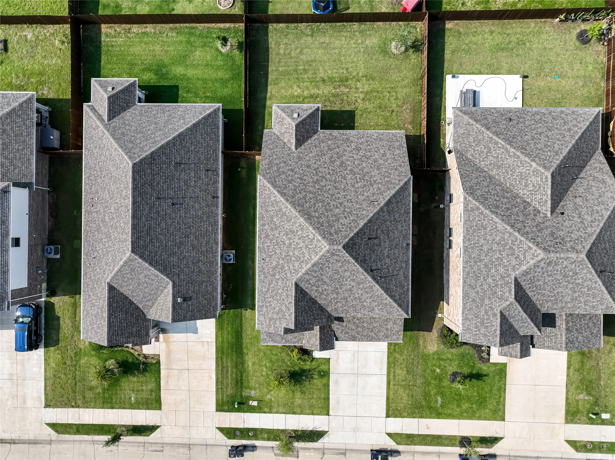 Gable and hip rooflines, individual driveways, and manicured lawns
