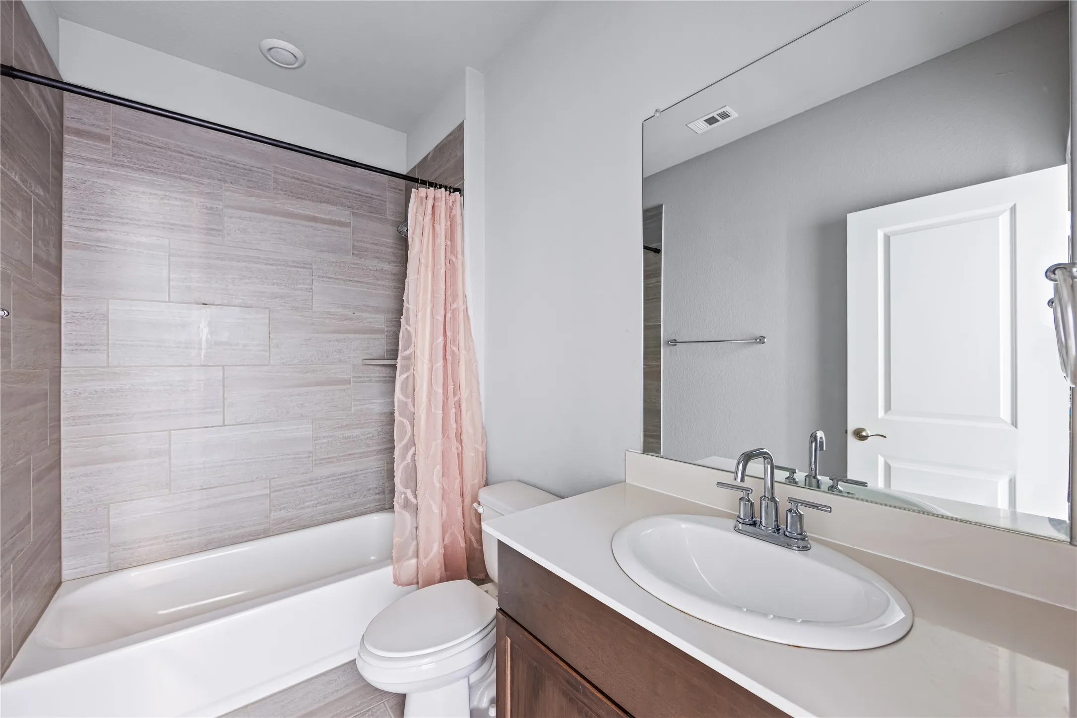 Vanity with a single basin sink and chrome faucet