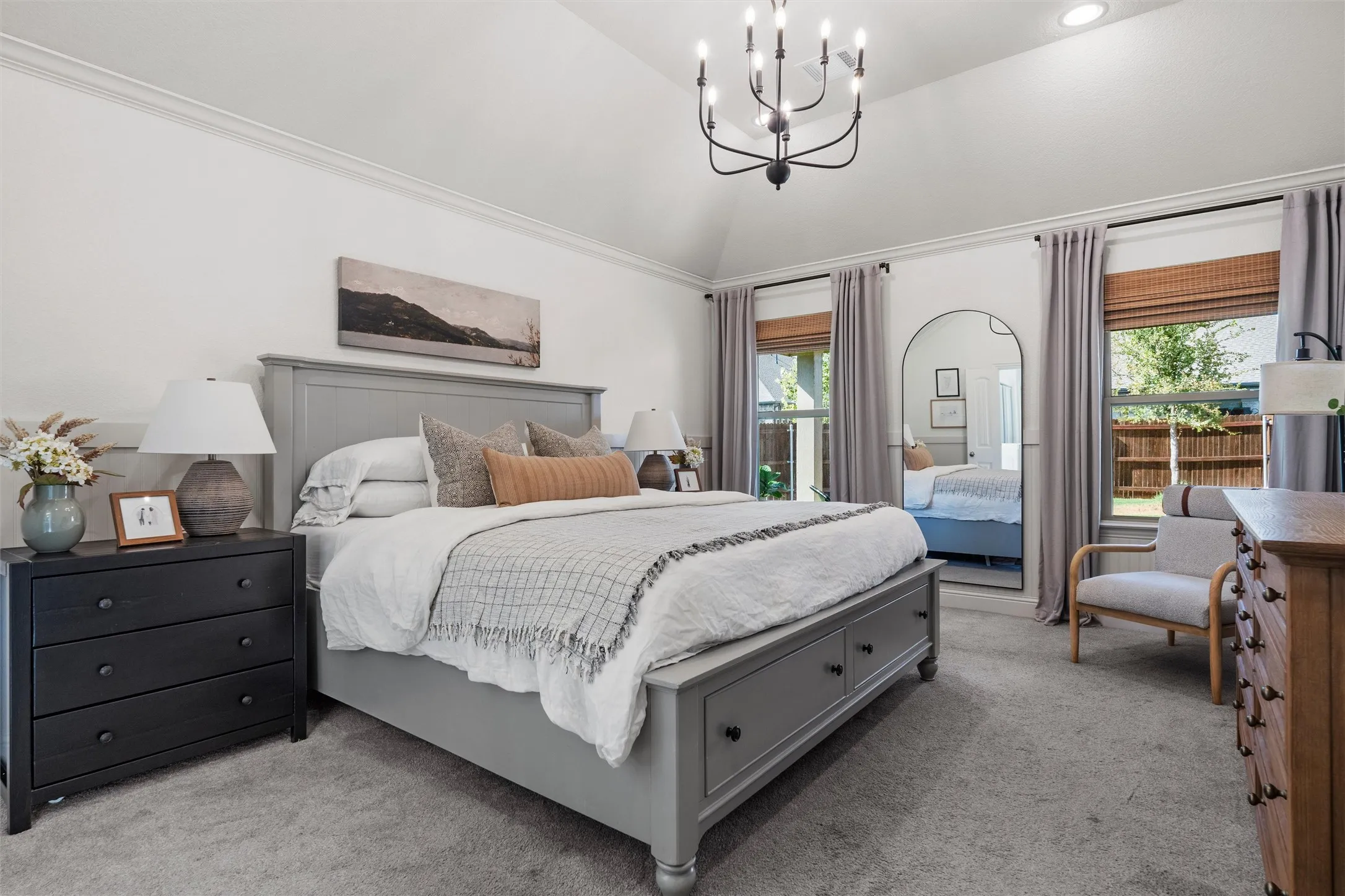 Vaulted ceiling with crown molding, recessed lighting, and a chandelier