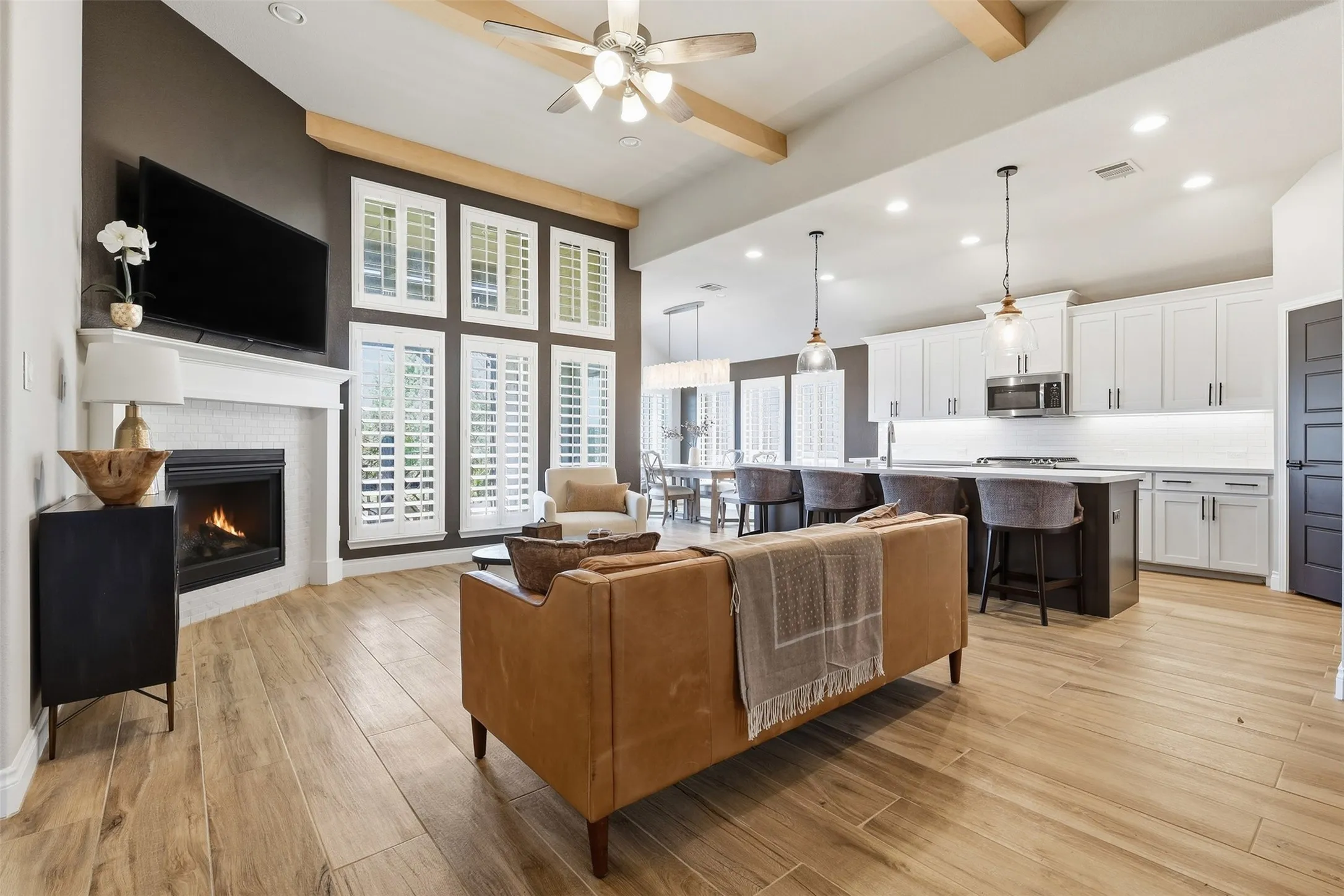 Vaulted ceiling with wood-finish beams and a ceiling fan