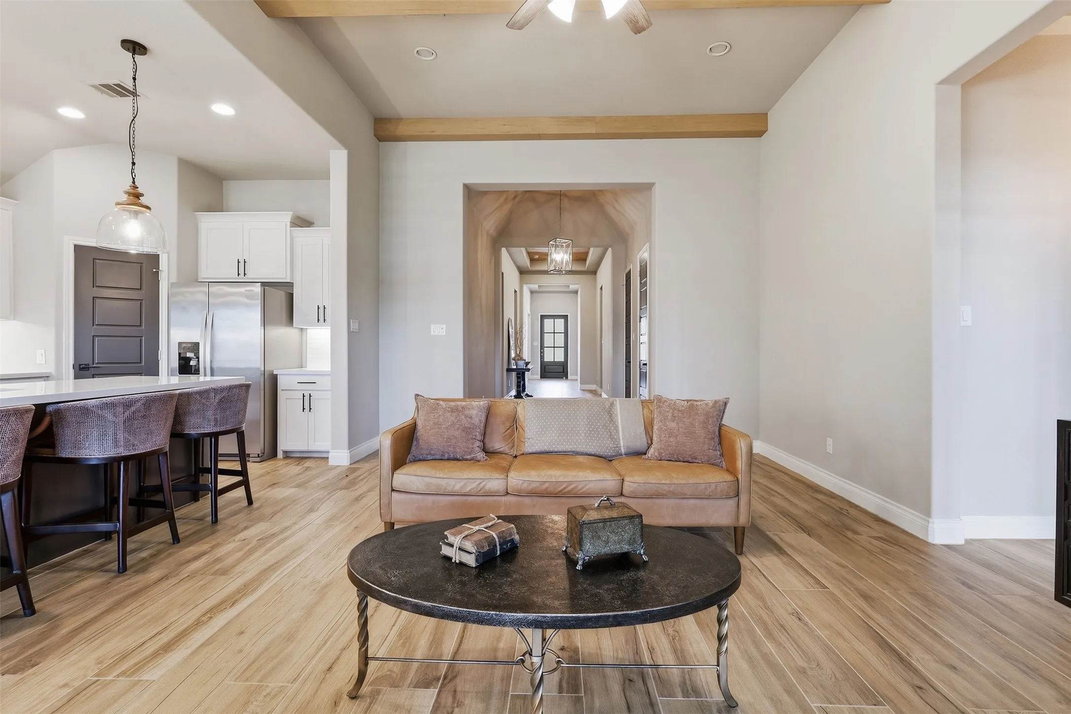Wood-finish flooring throughout, complemented by exposed ceiling beams