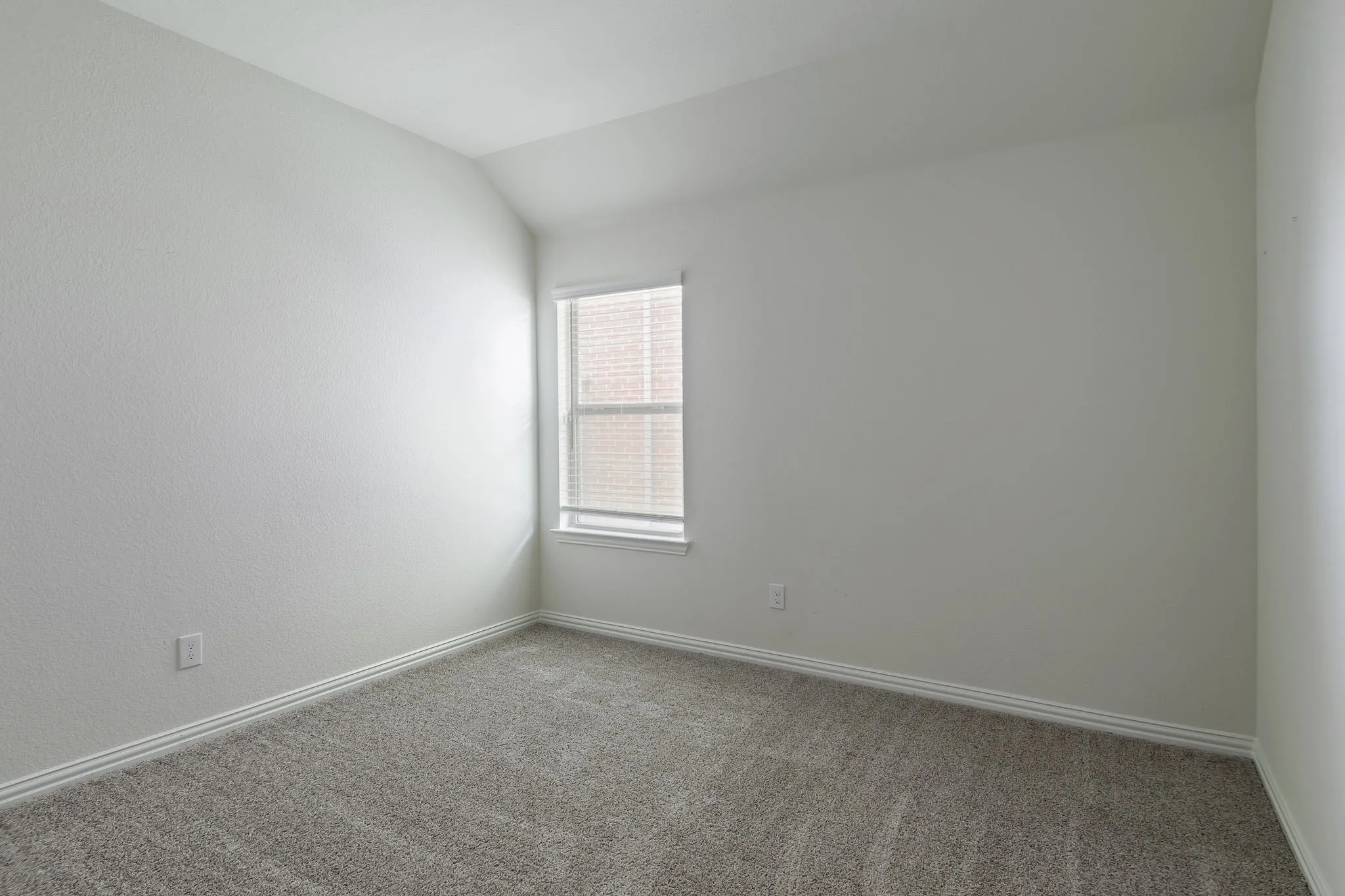 Neutral wall finishes and gray carpet