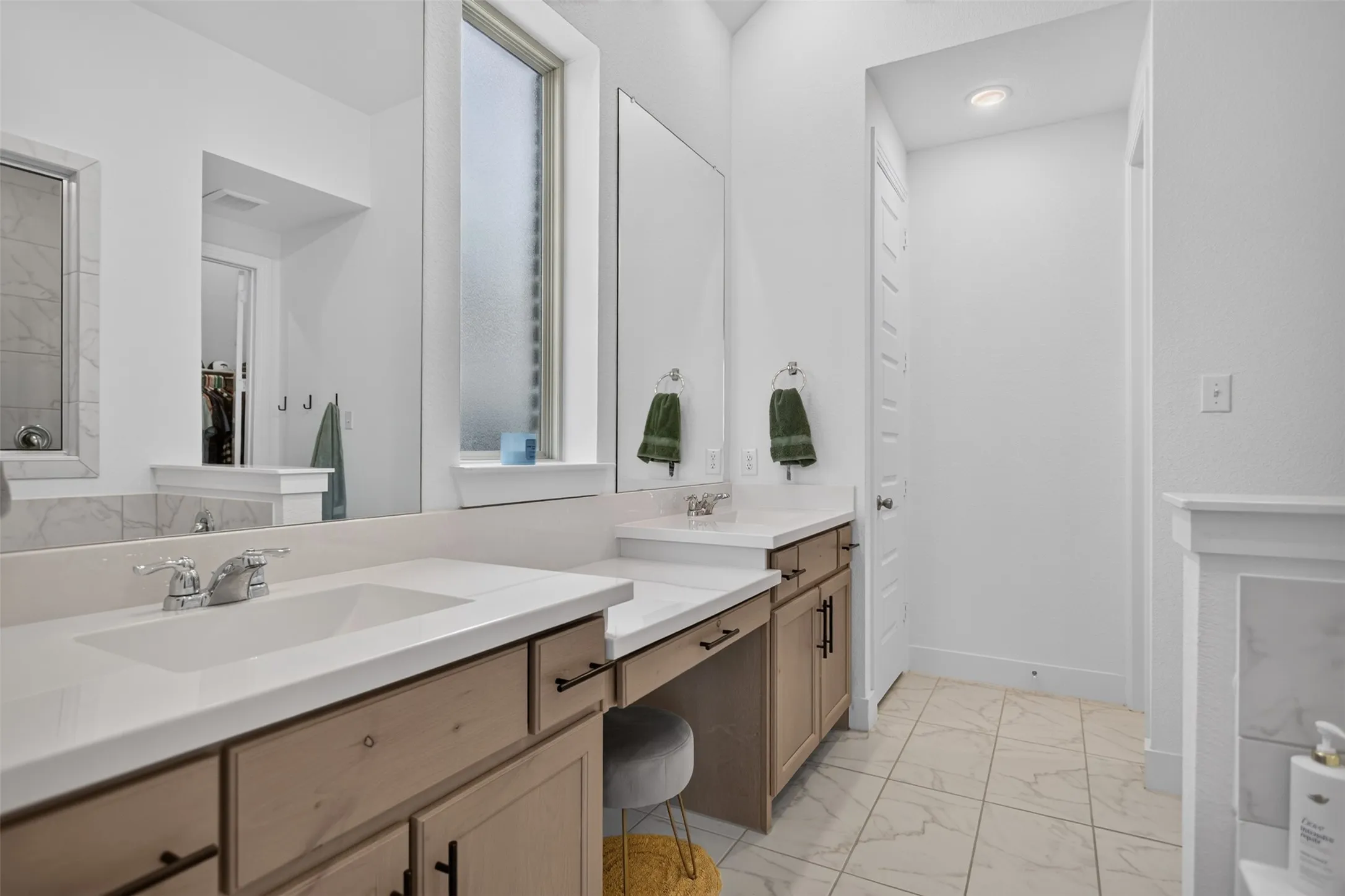 Dual vanity with undermount sinks and light wood-finish cabinetry