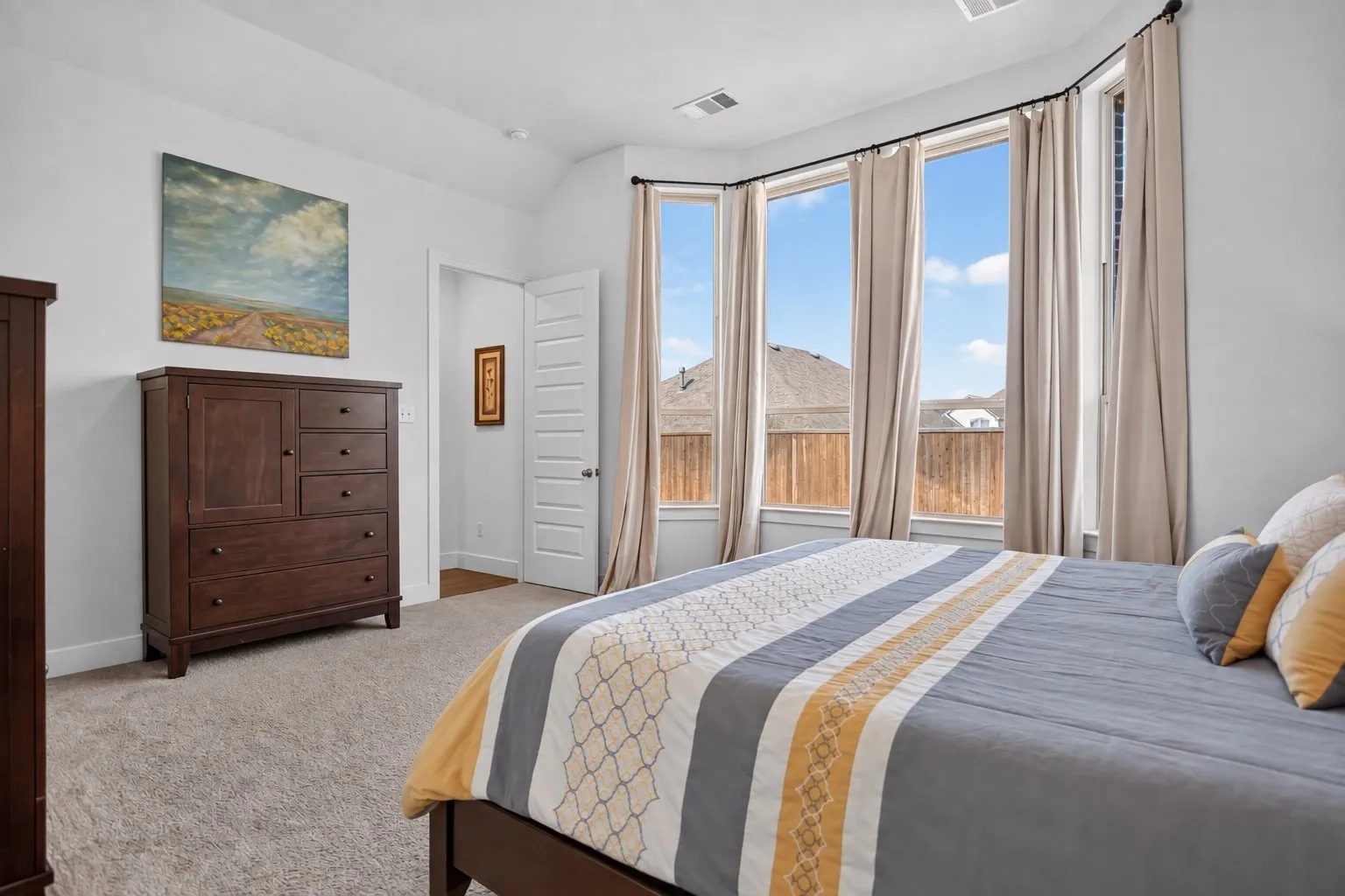 Bay window with multiple vertical panes, light-toned walls, and recessed ceiling lighting