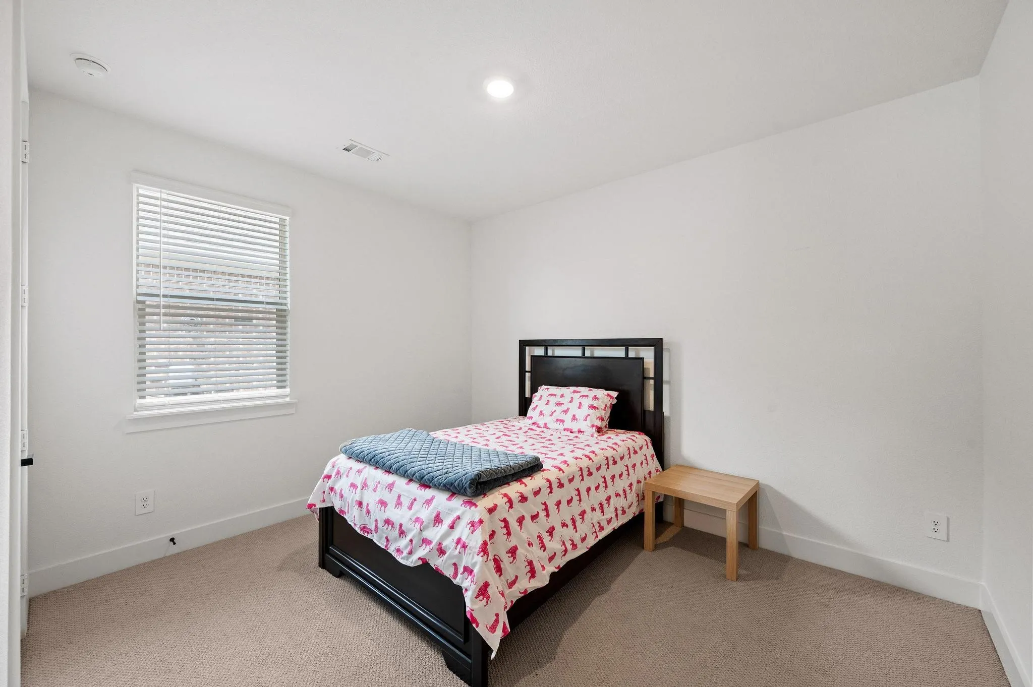 Recessed ceiling lighting, white walls, window with blinds, carpeted flooring, and a white ceiling