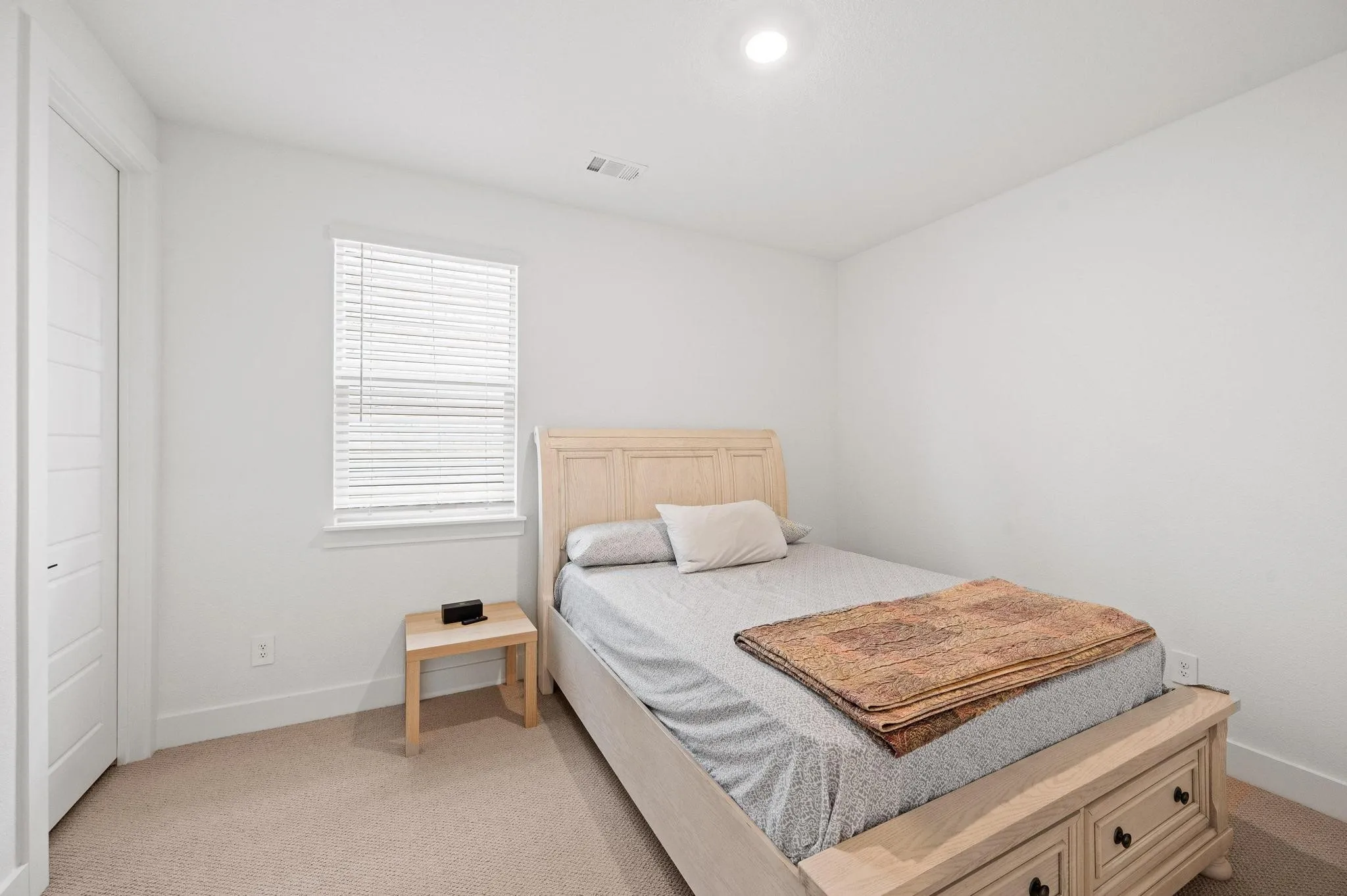 Recessed ceiling lighting, window with blinds, panel closet door, light-toned carpet flooring, and neutral wall finishes