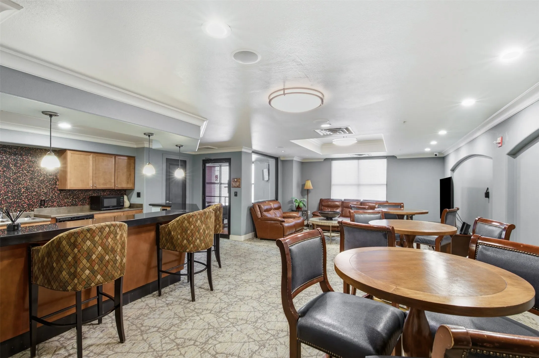 Built-in wet bar with wood cabinetry and pendant lighting
