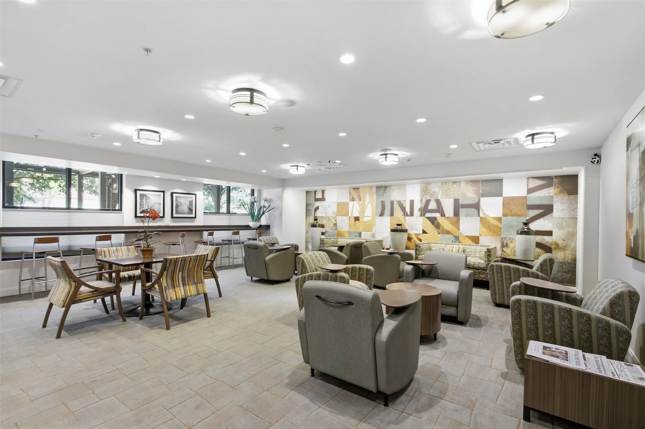 Recessed lighting, flush-mount ceiling fixtures, tiled flooring, long accent windows, and a decorative wall mural