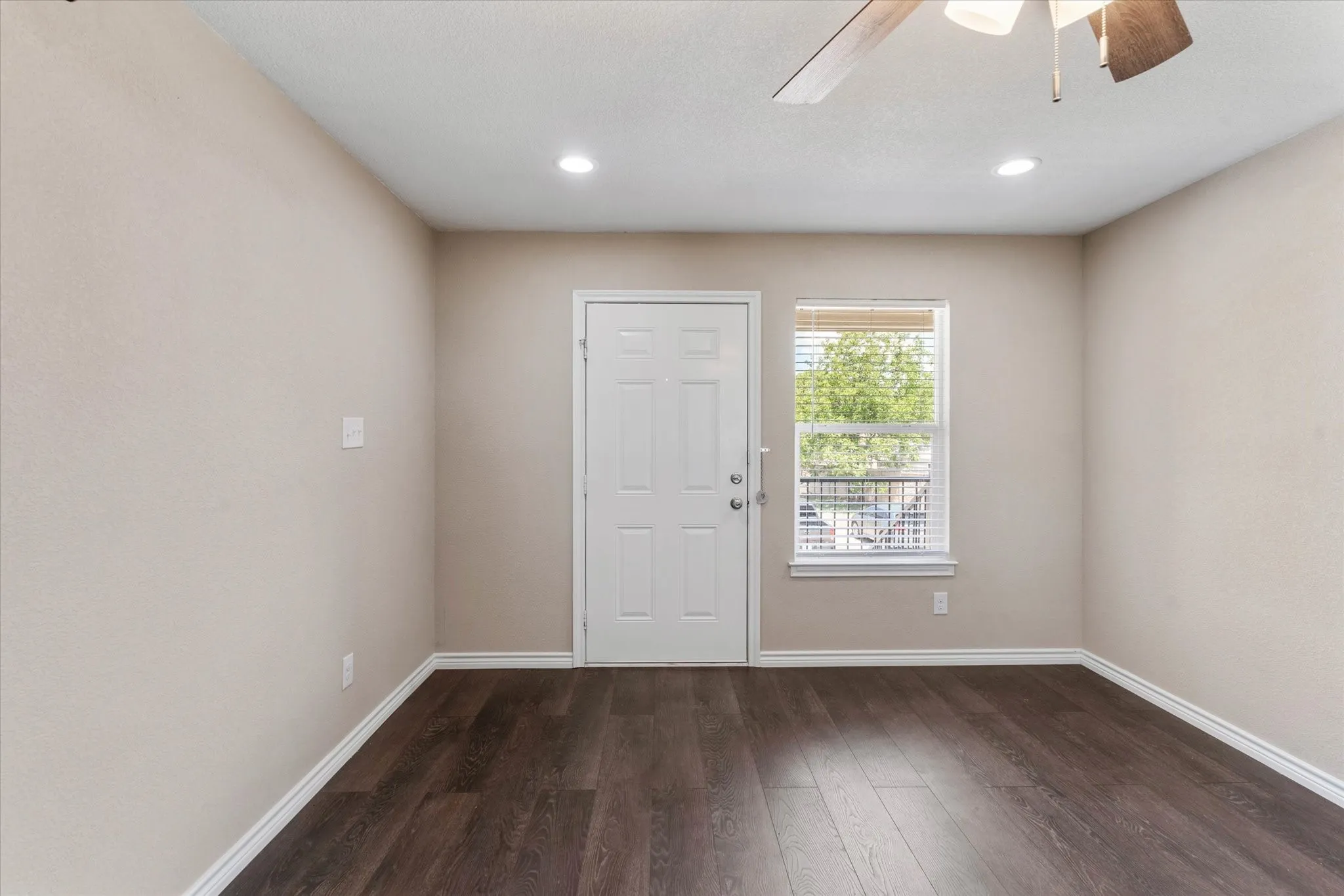 Spare room featuring wood-type flooring and ceiling fan