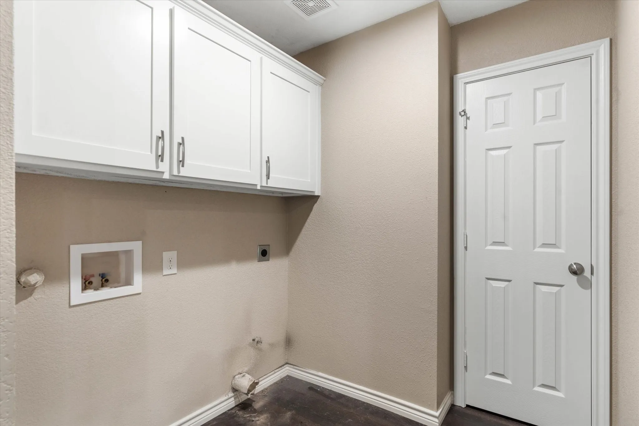 Laundry room featuring gas dryer hookup, hookup for a washing machine, dark hardwood / wood-style floors, cabinets, and electric dryer hookup